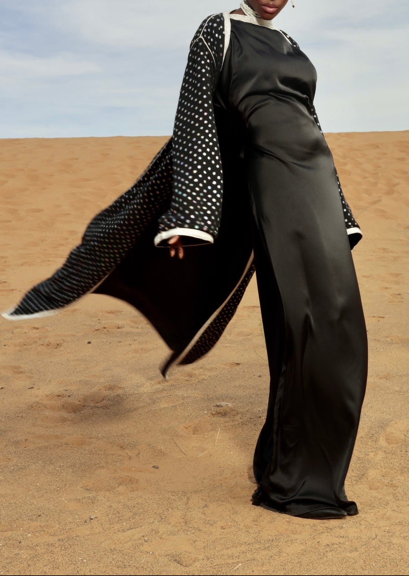 Black tulle abaya kimono embellished with sfifa and sparkling rhinestones, shown in motion.