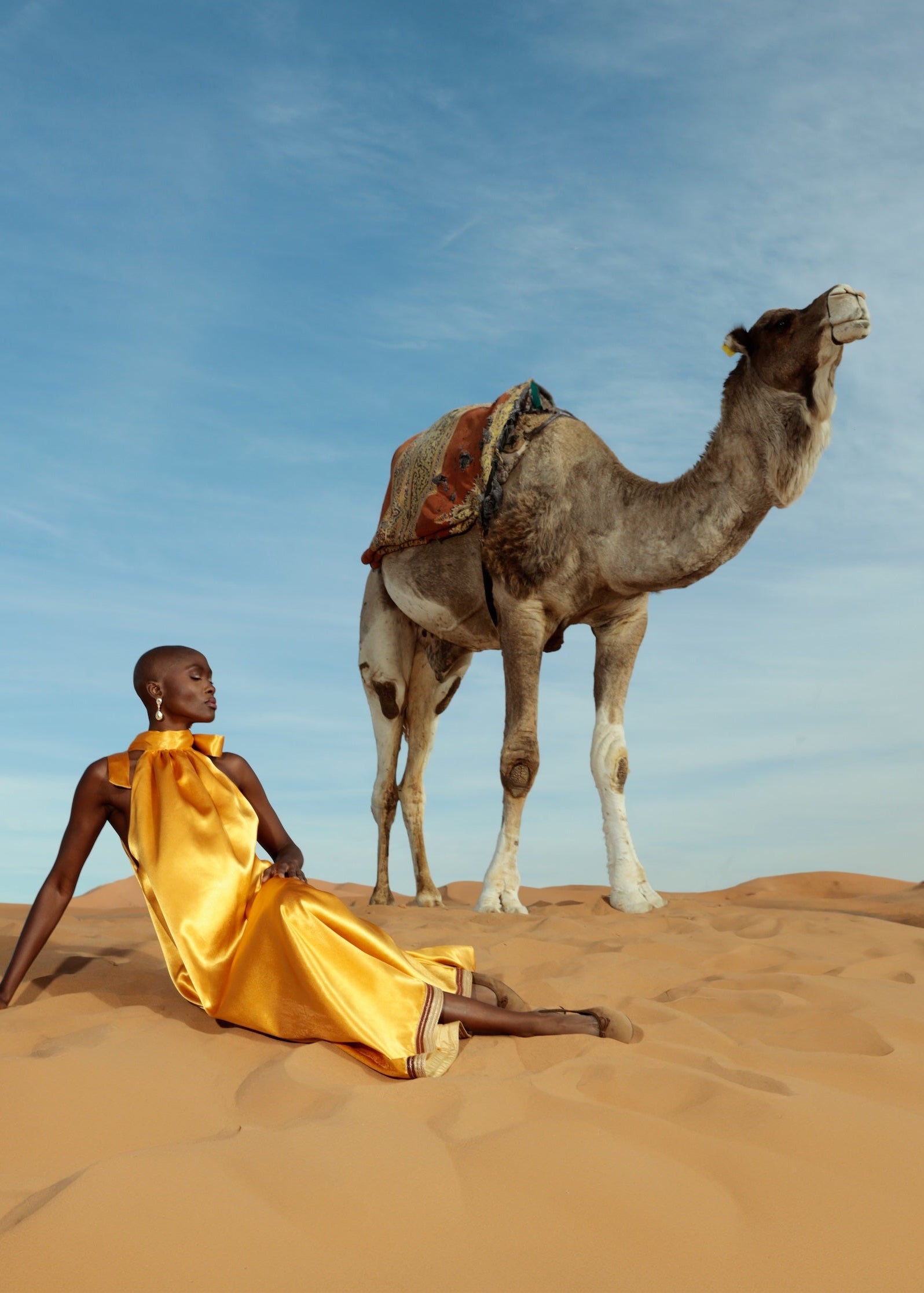 Orange duchesse satin dress adorned with handcrafted sfifa, shown in motion.