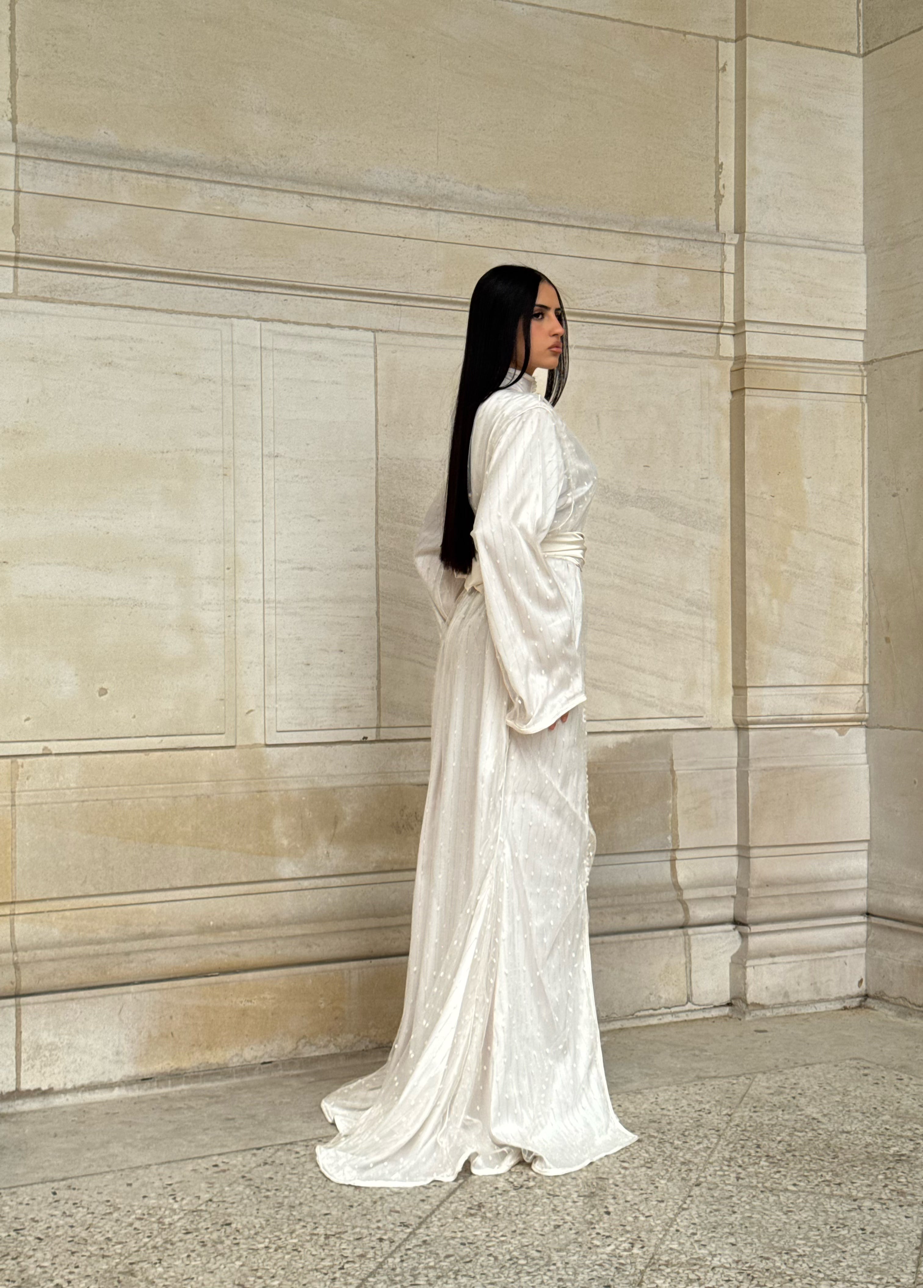 Side view of Kaftan white Kaftan with a high neckline and flowing silhouette