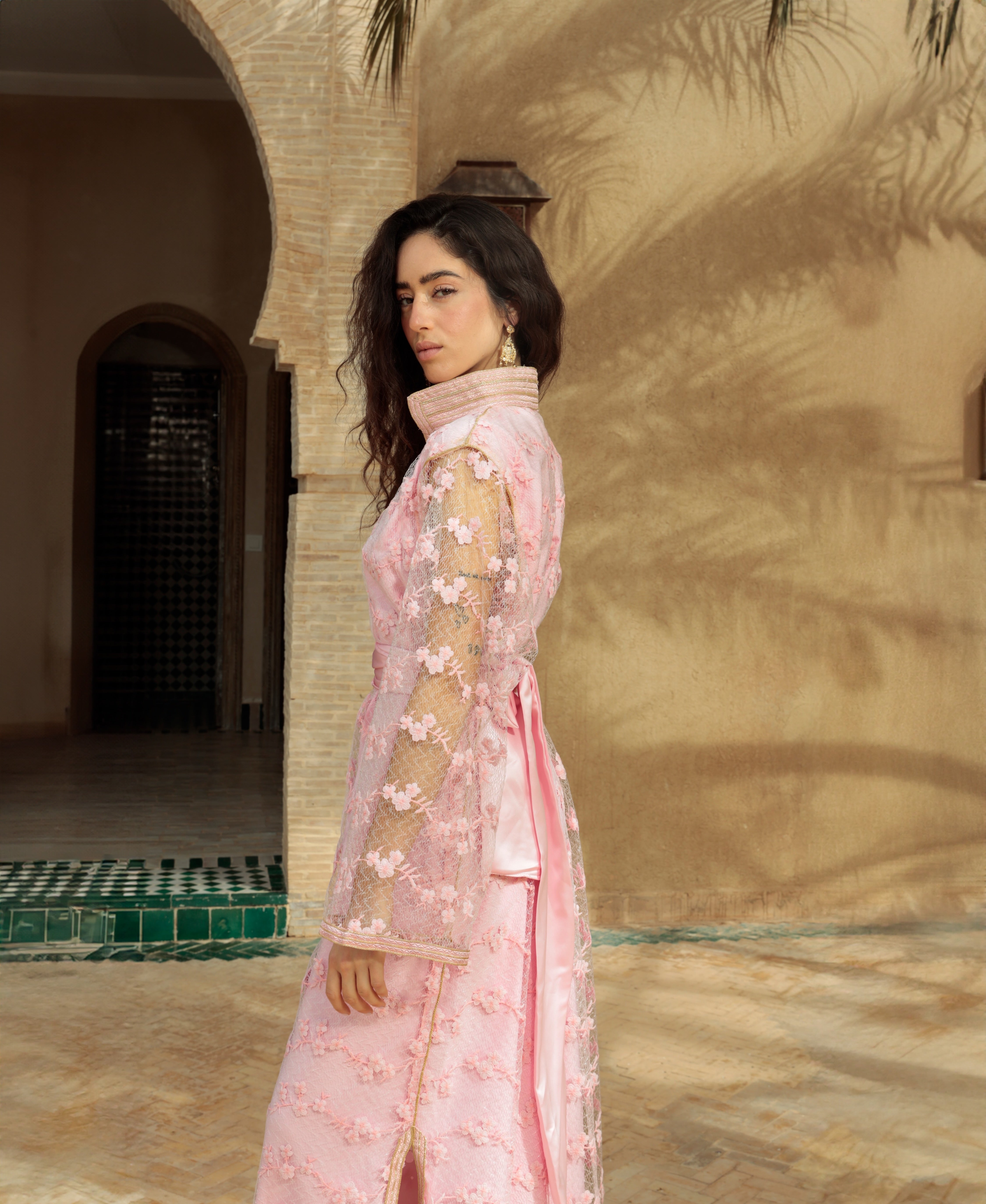 Close-up of the pink lace and raised flowers on a Kaftan