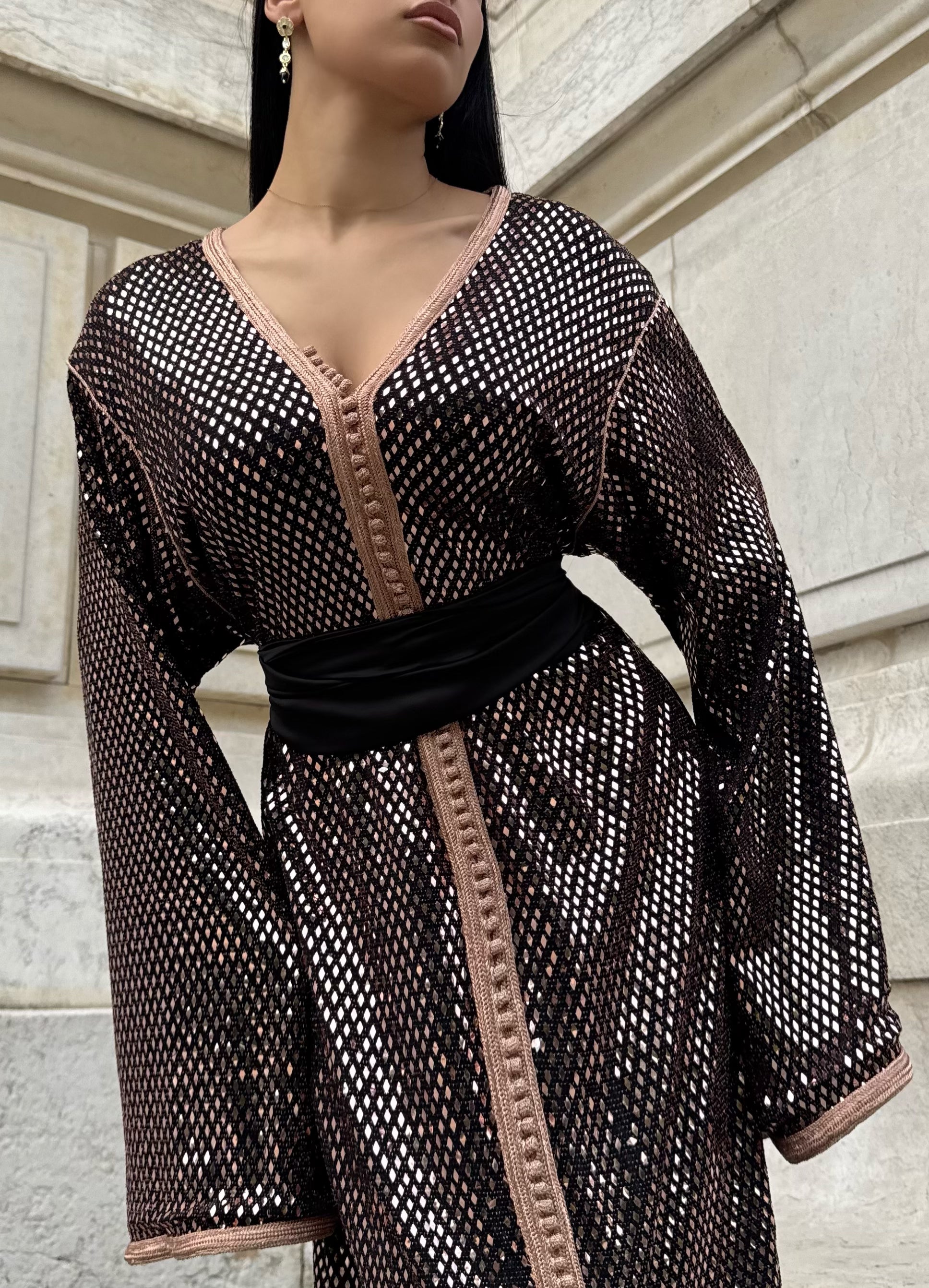Close-up of the bronze diamond print on a black Kaftan