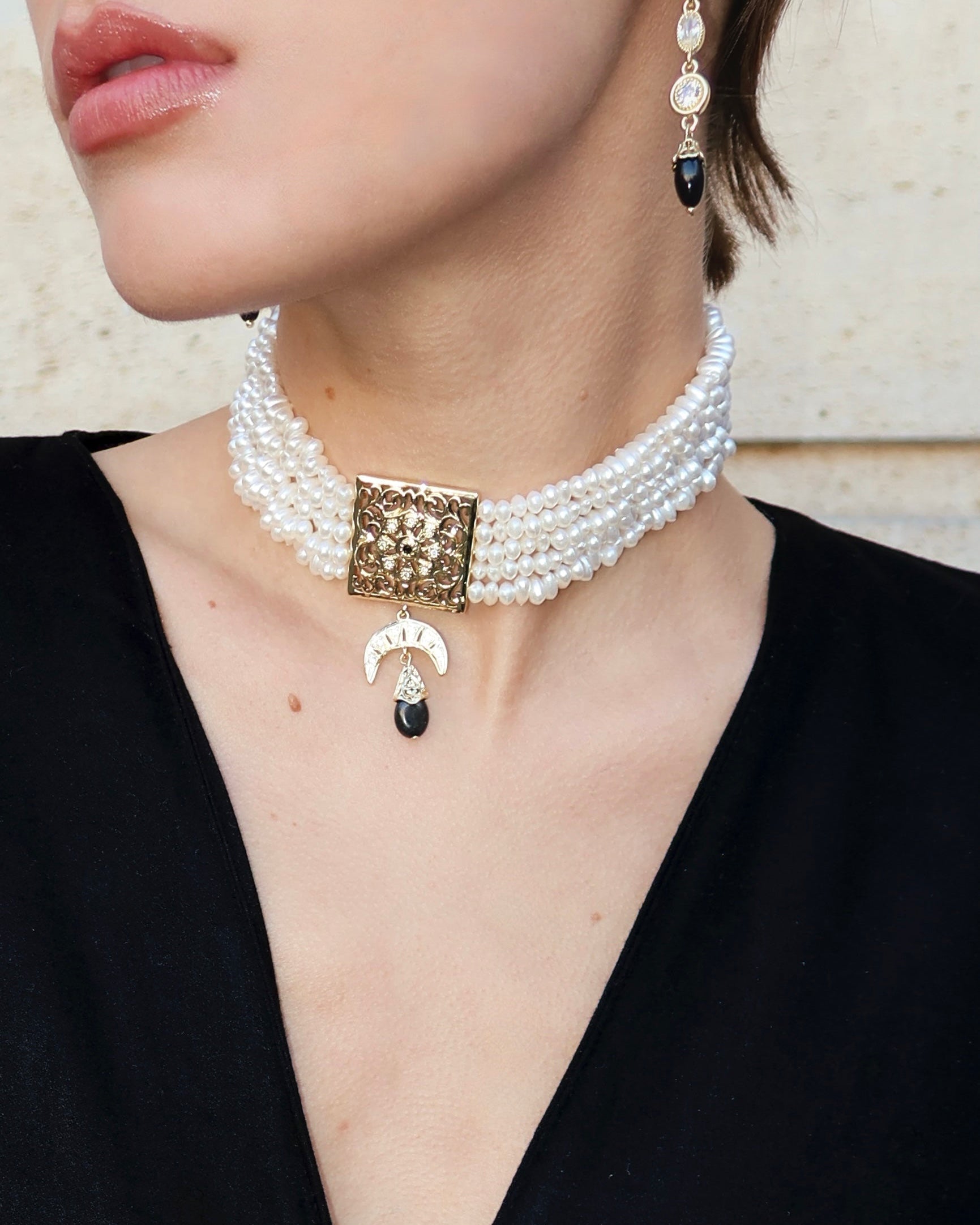 Gold and black beaded choker with a central medallion, a piece of contrasting oriental jewelry