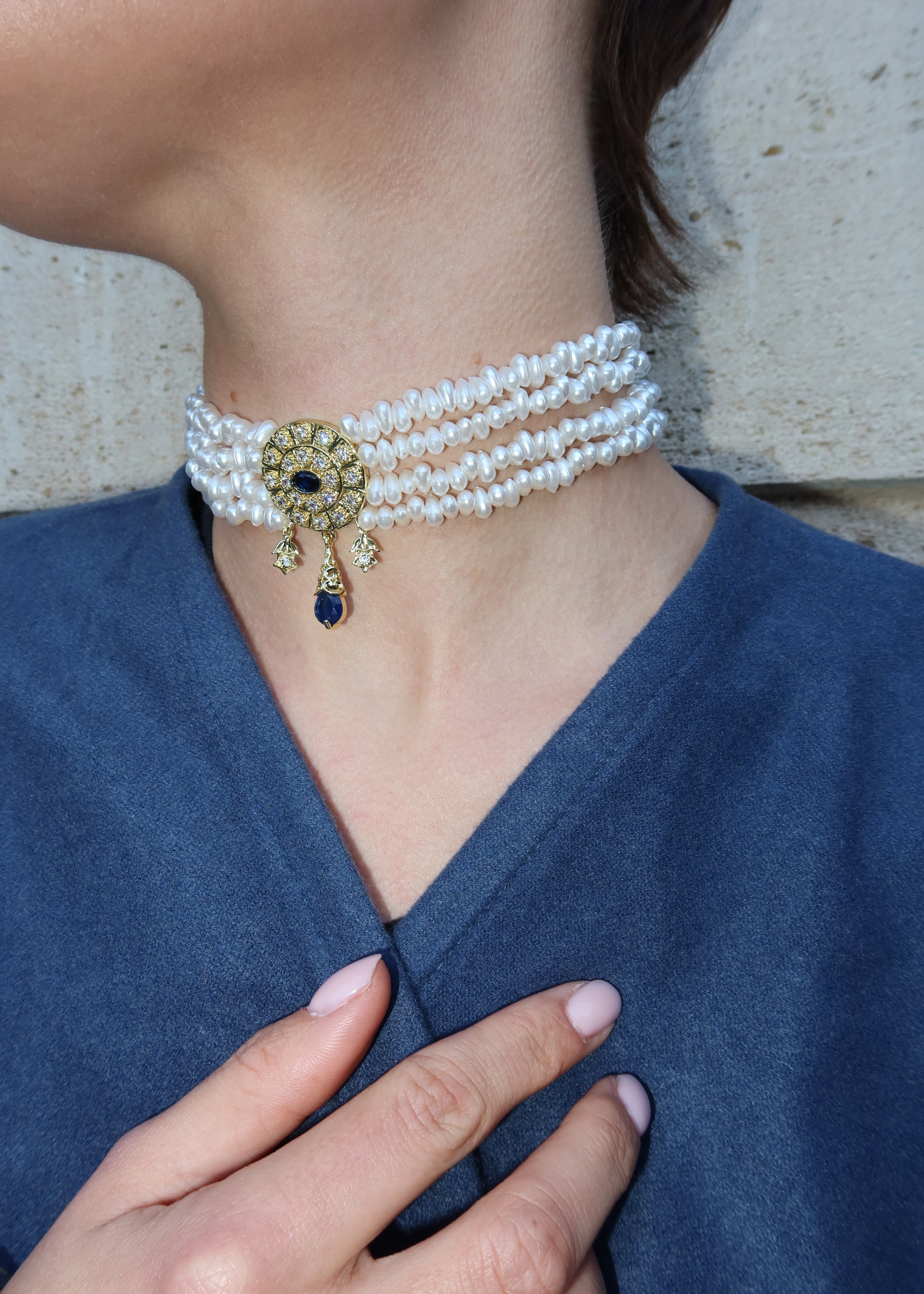 Choker necklace with pearls, a gold medallion, and a blue stone, oriental-style jewelry