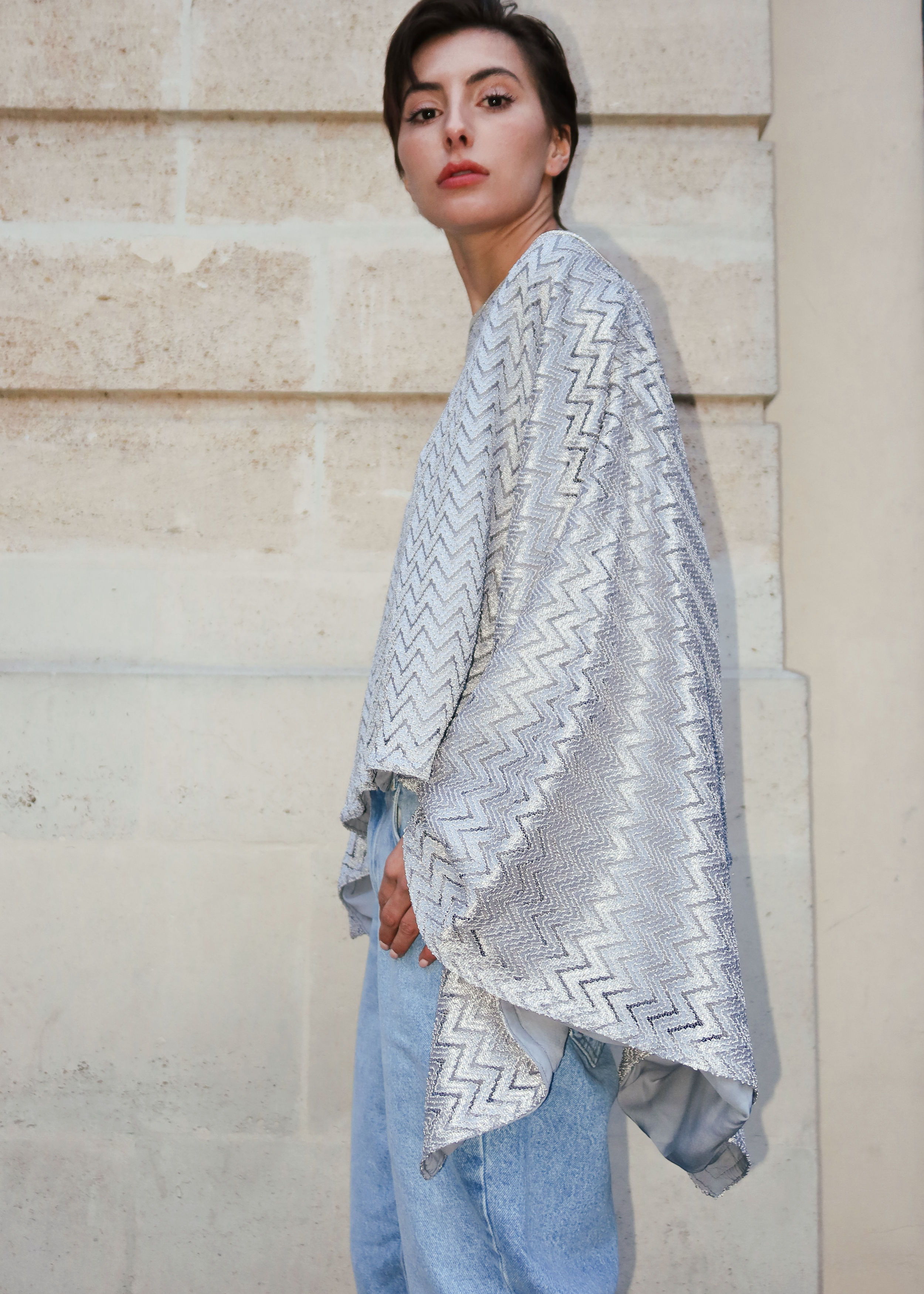Gray top with a silver chevron jacquard pattern, worn with jeans