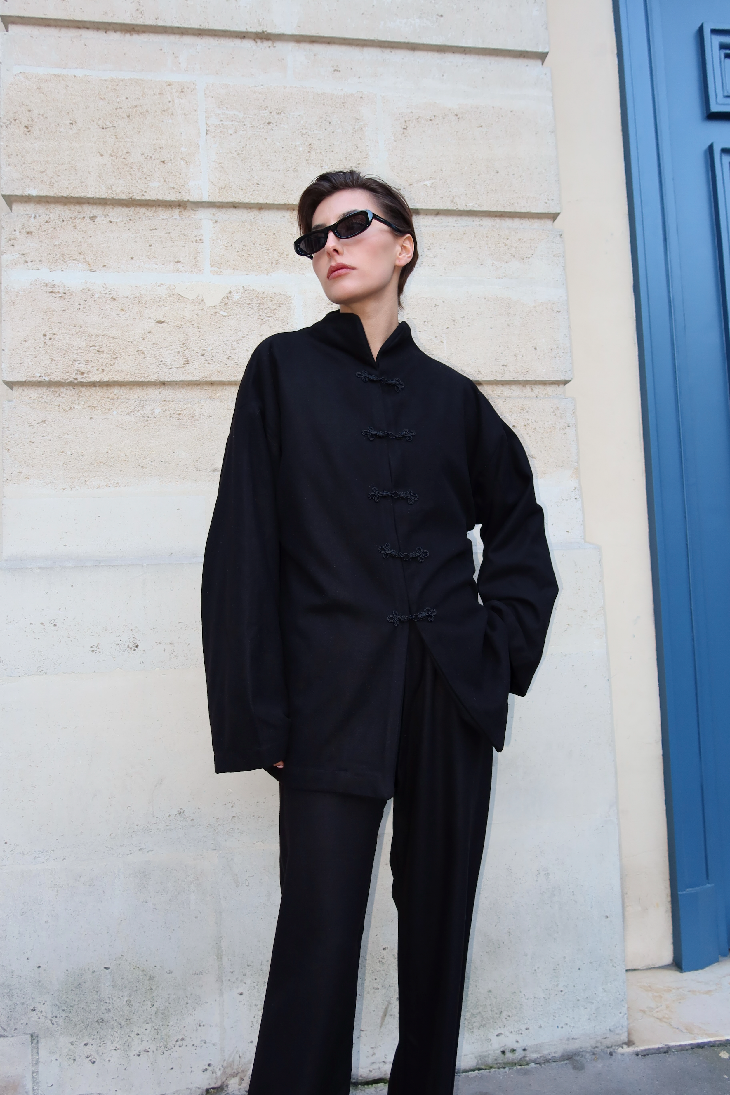 Moroccan black cashmere ensemble worn from the front, adorned with handmade Moroccan buttons