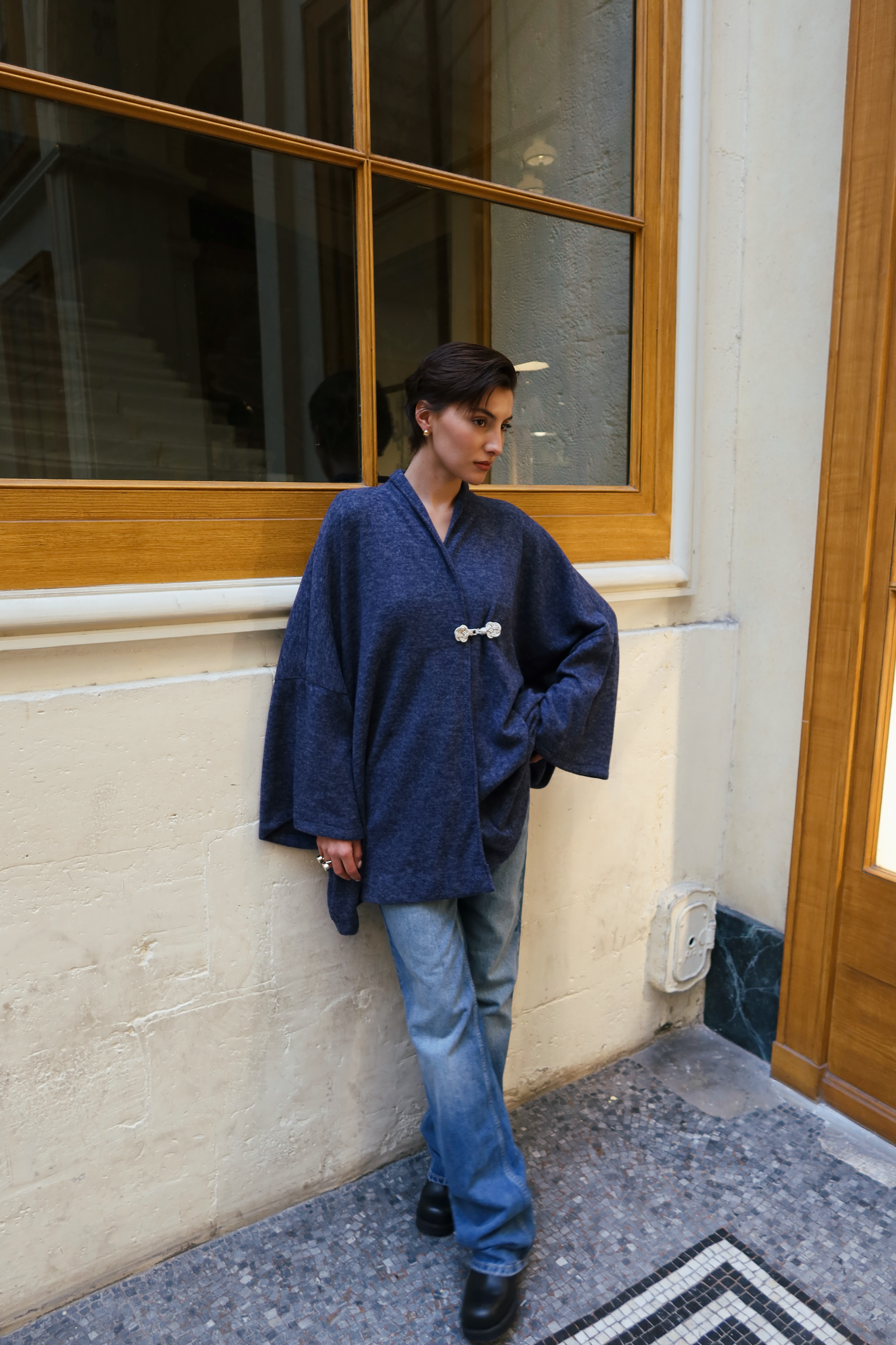 Blue wool cardigan photographed full length, with hook closure and chic style