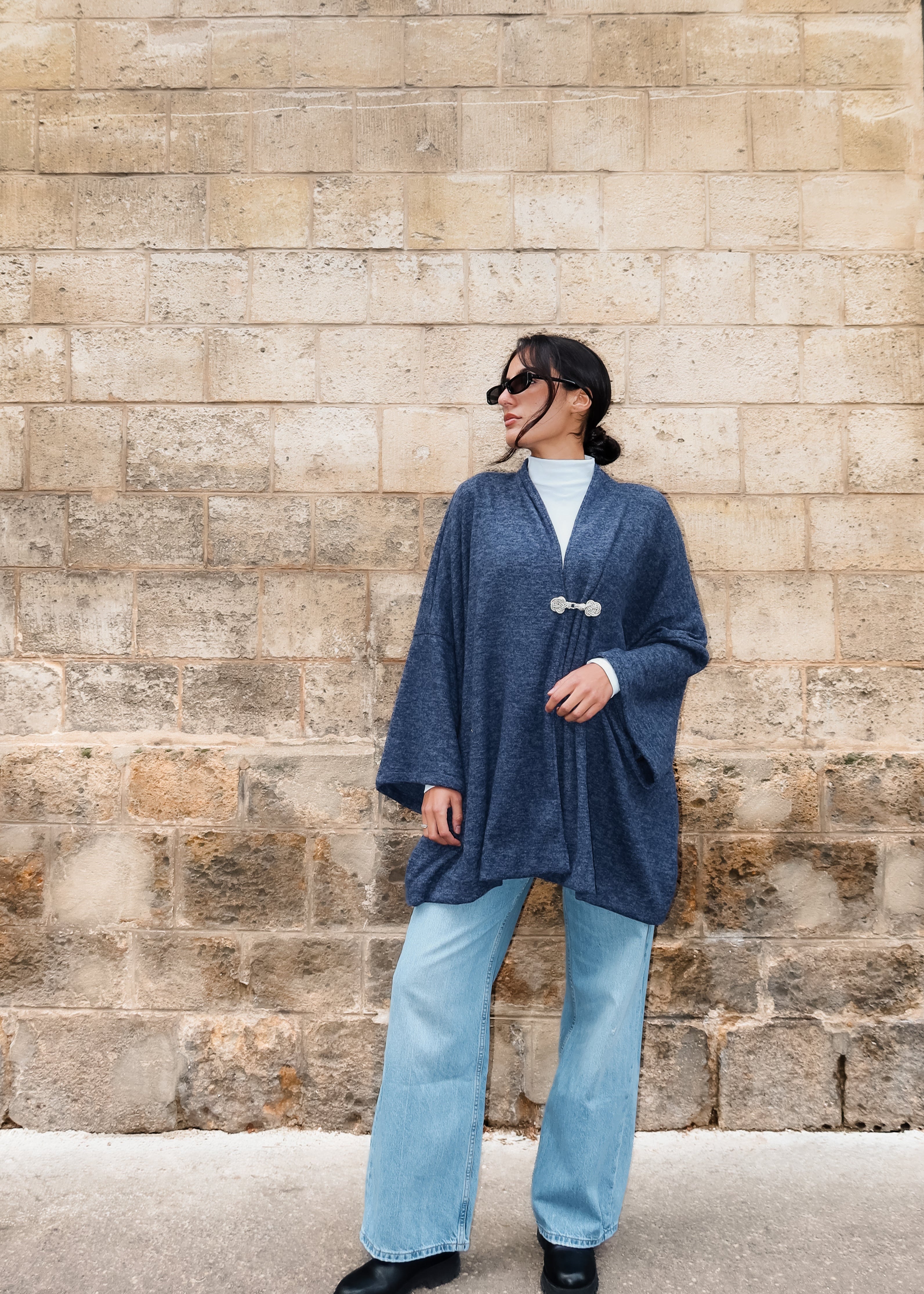 Long blue cashmere cardigan with silver Moroccan crochet worn in motion