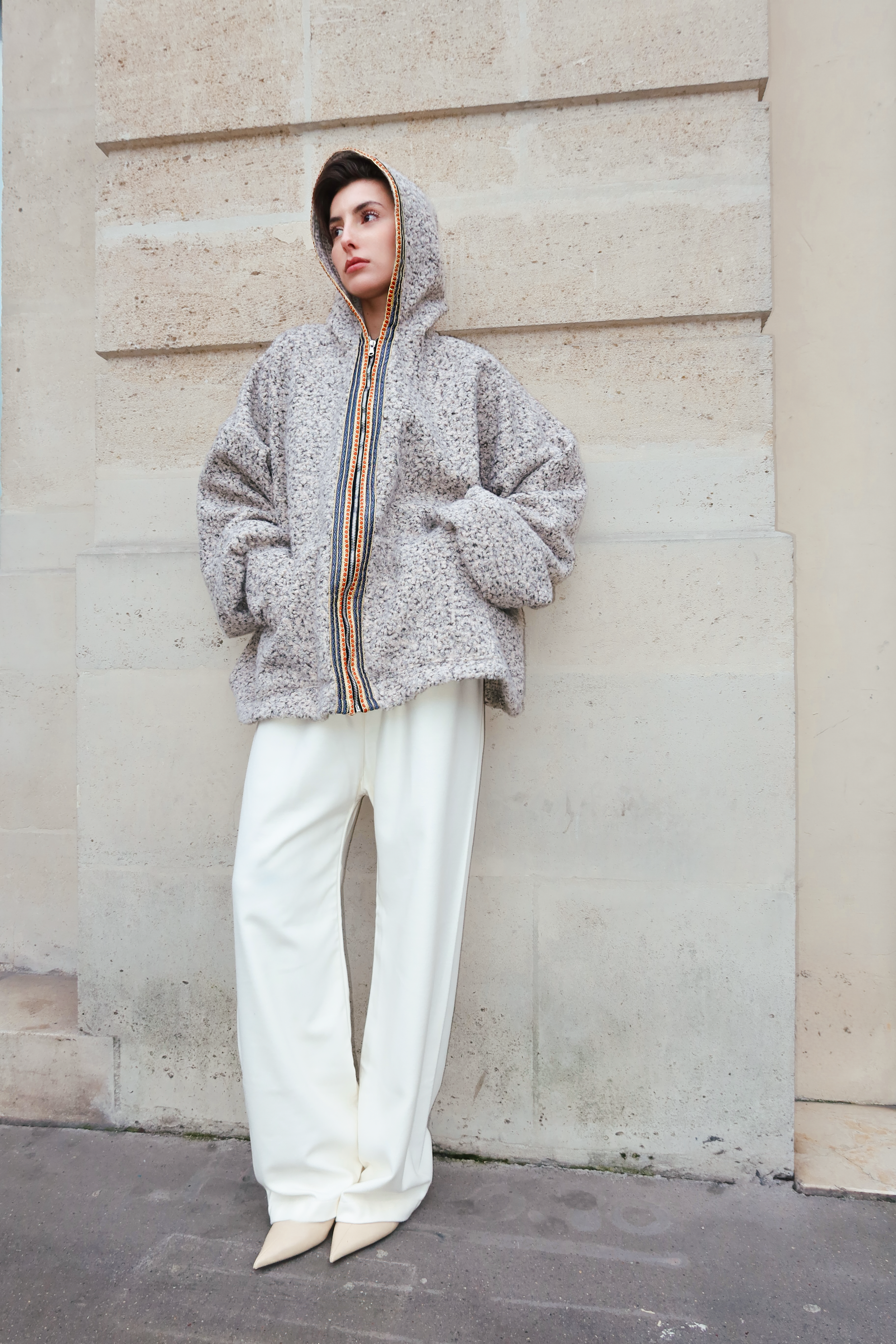Beige bouclé wool cardigan revealing a soft bouclé texture and refined sfifa detailing