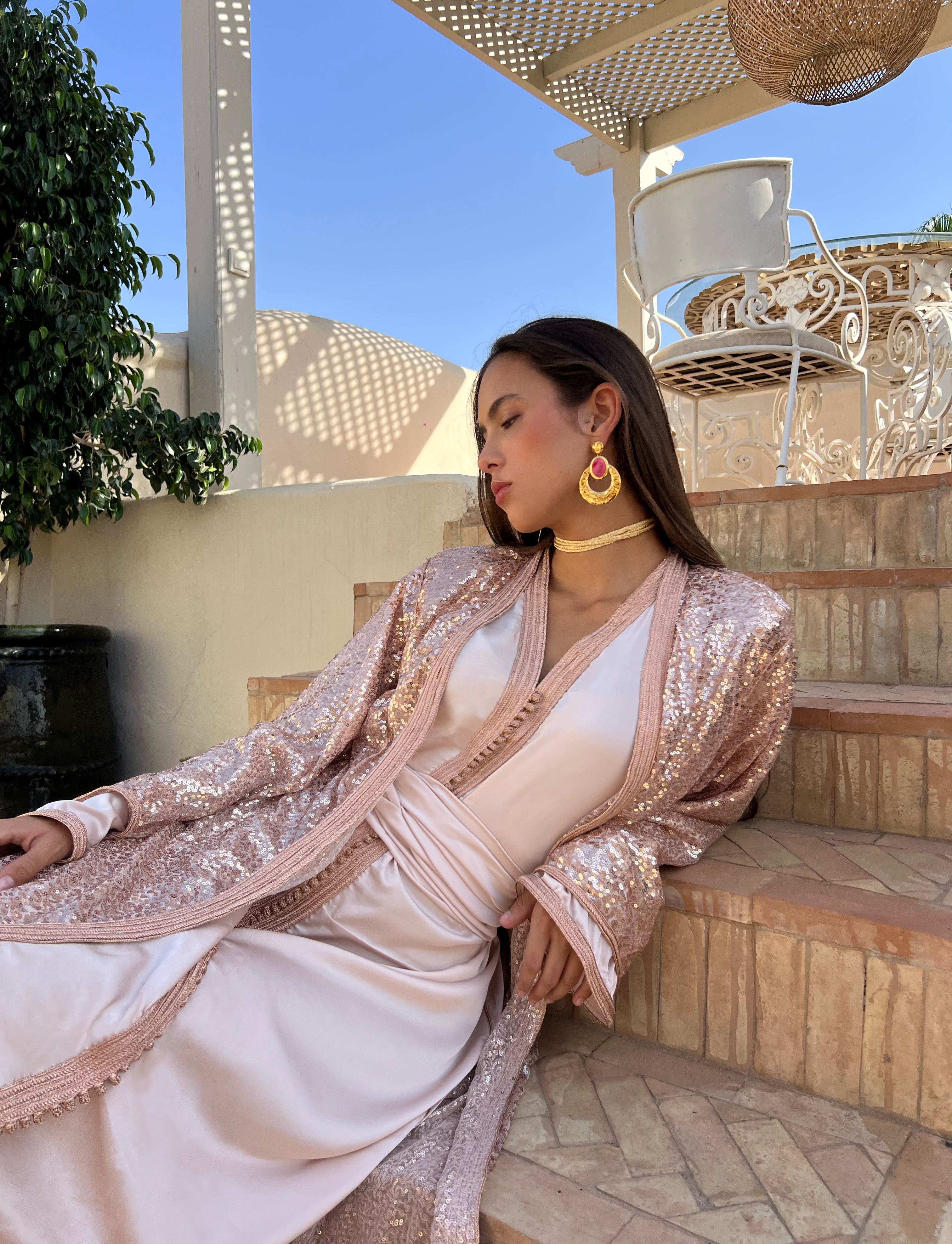 Beige Kaftan in moving beaded tulle, flowing fabric and pearls glinting in the light