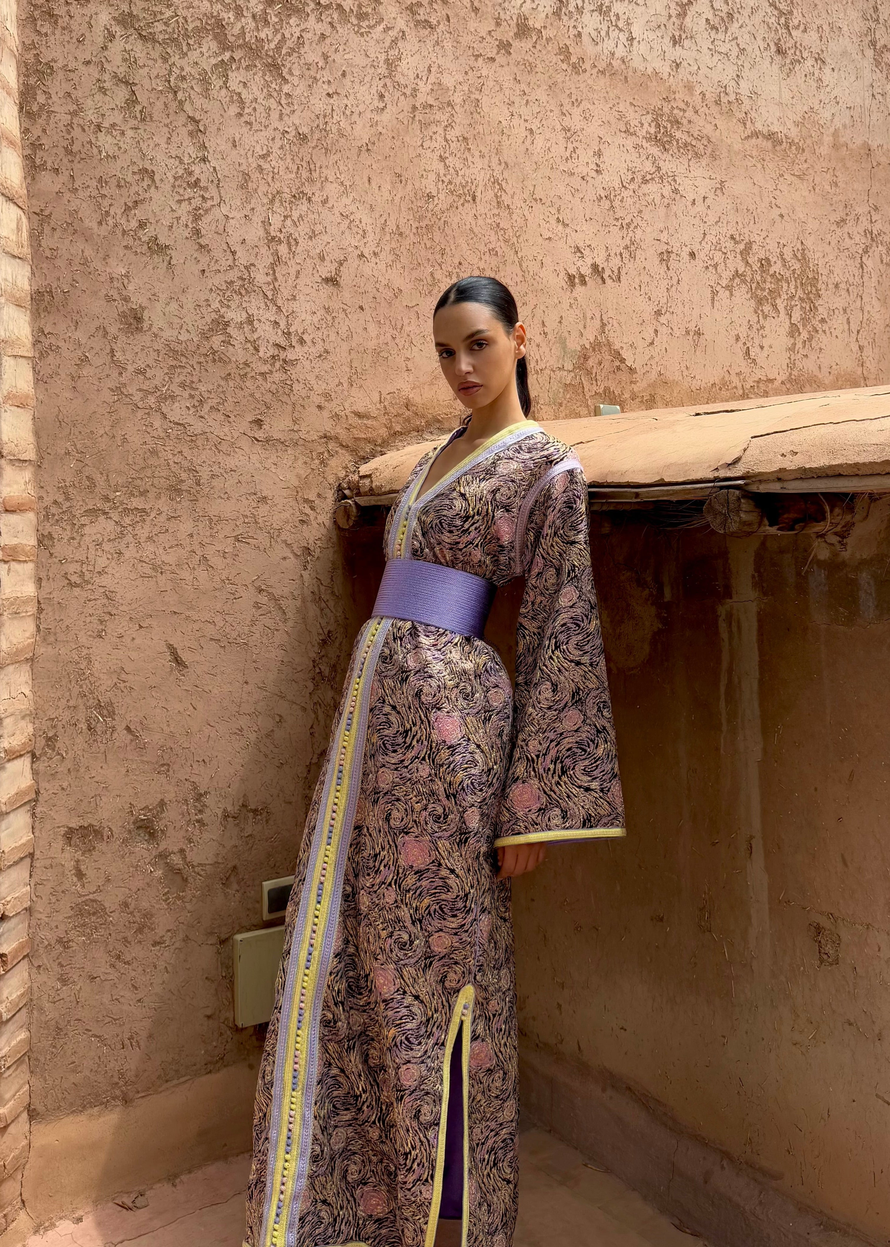Multicolored brocade Kaftan worn all over, with visible purple and yellow details