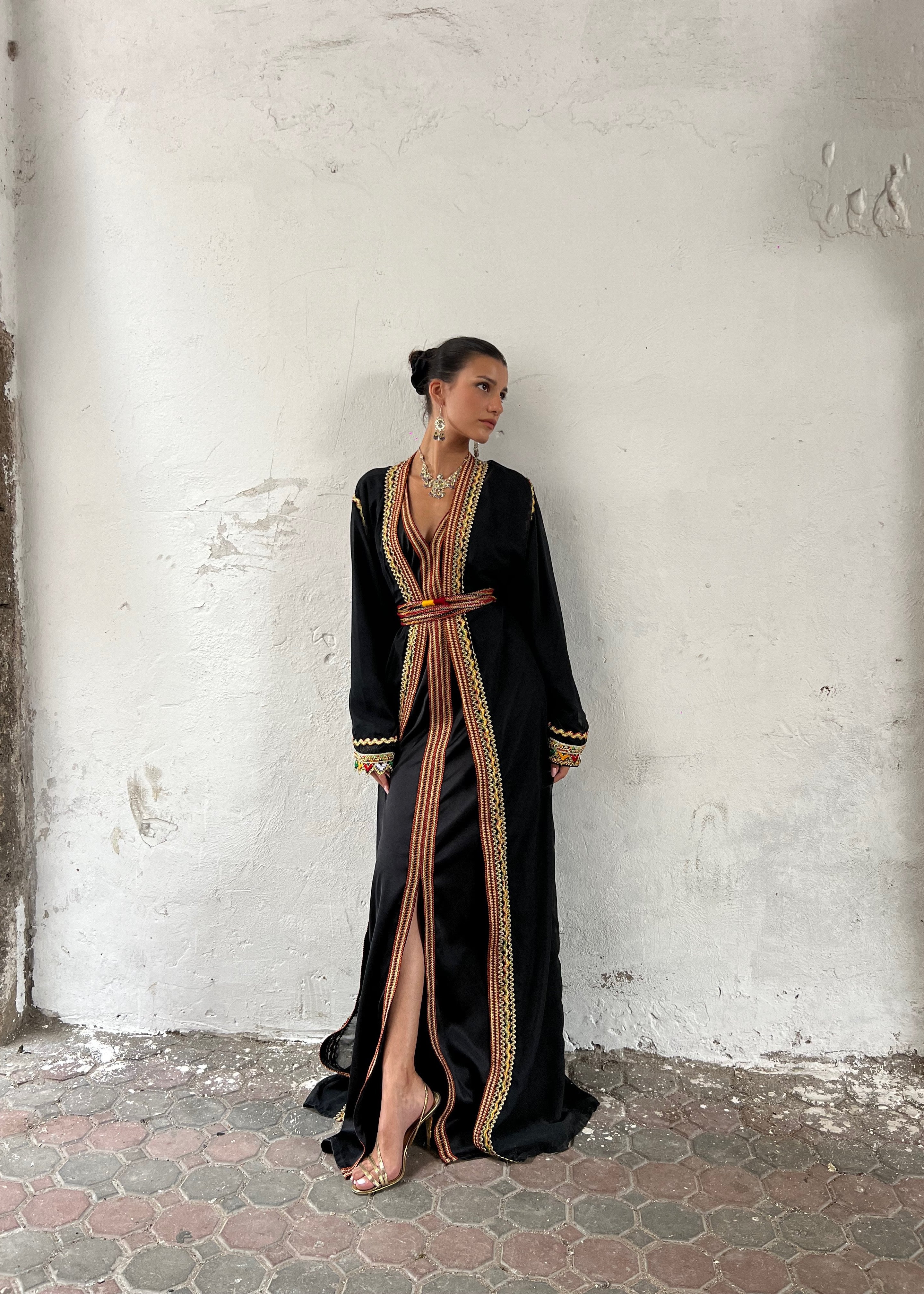 Black Kabyle Kaftan seen from the front, featuring a traditional cut enhanced by emblematic colorful embroidery.