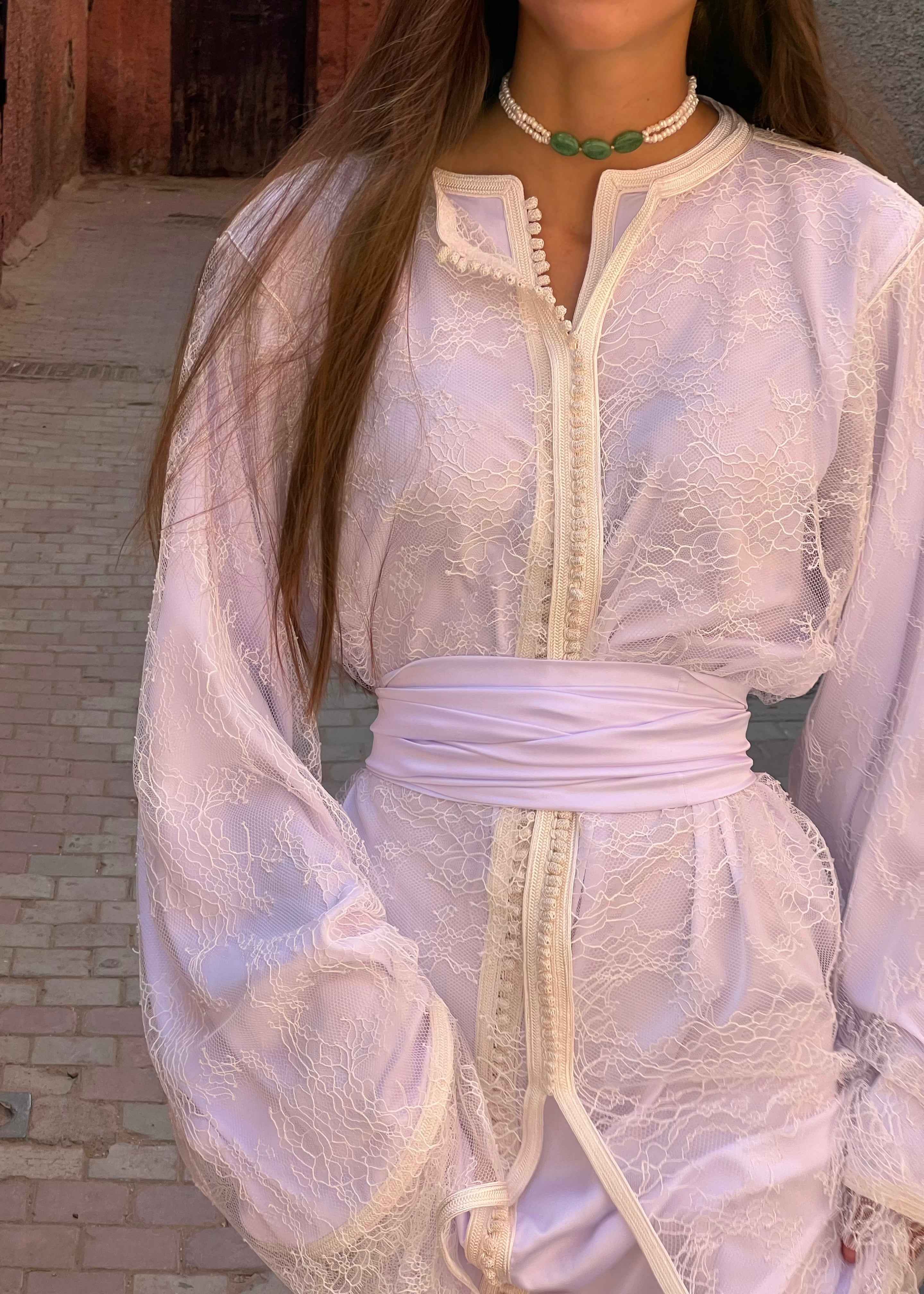 Detail of the collar and sleeves of the white bridal Kaftan in Calais lace, beaded finishes and hand-crafted stitching.
