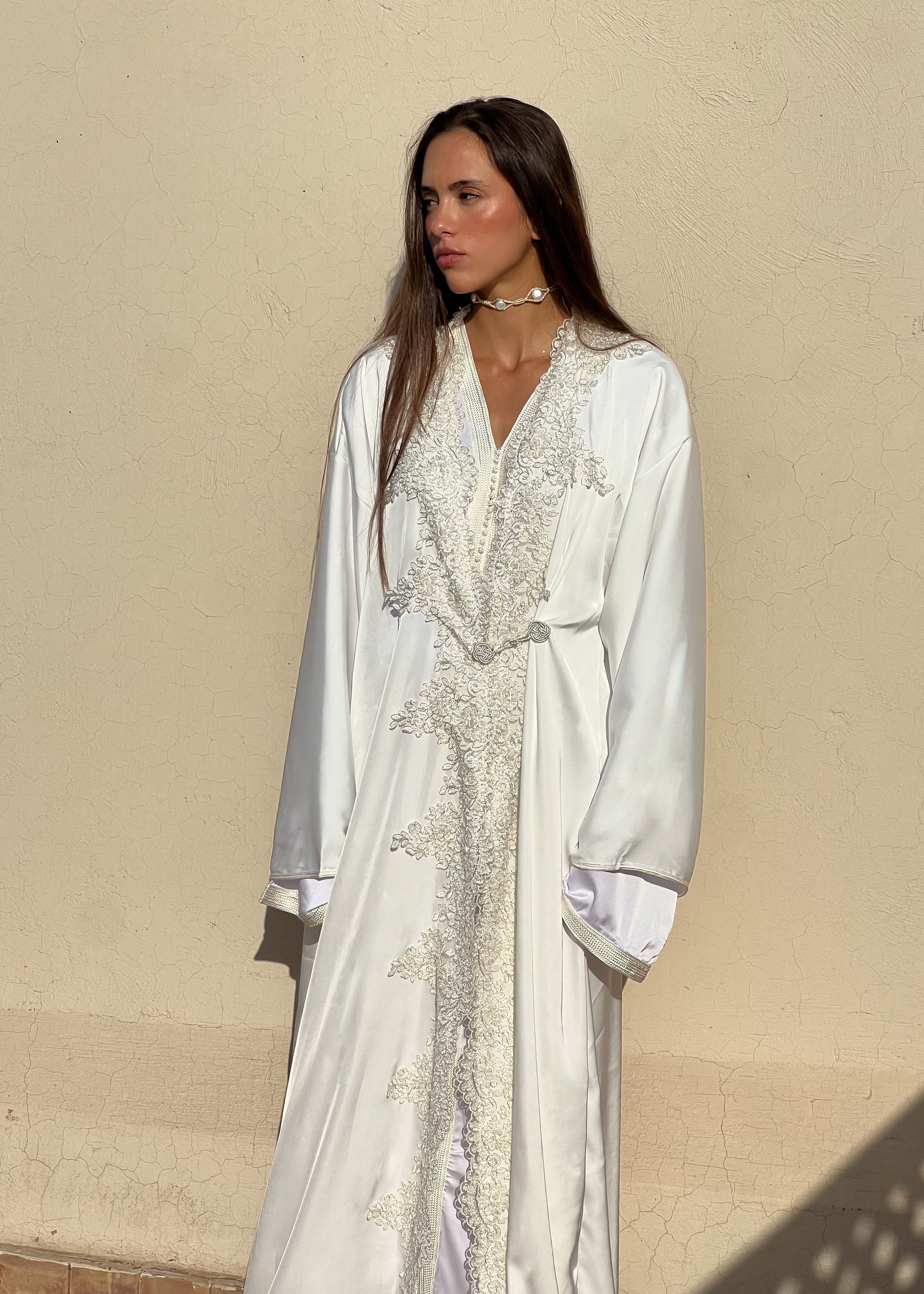 Bridal Kaftan in white silk with sequined lace, elegant cut and refined look, front view on mannequin
