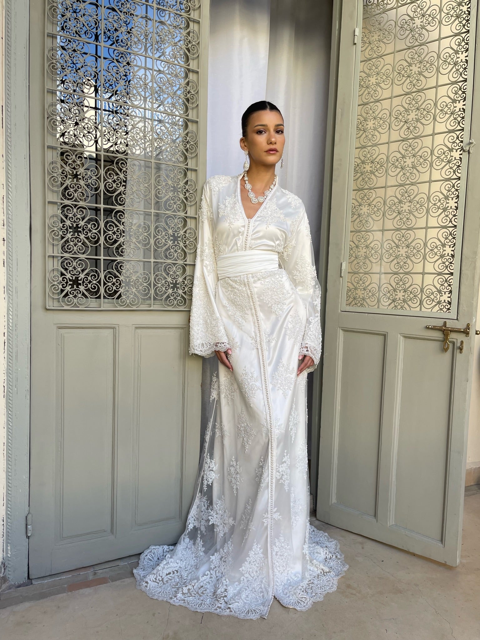 Bridal Kaftan in beaded tulle with officer's collar captured in motion, highlighting the fluidity of the fabric and the light of the embroidered beads.