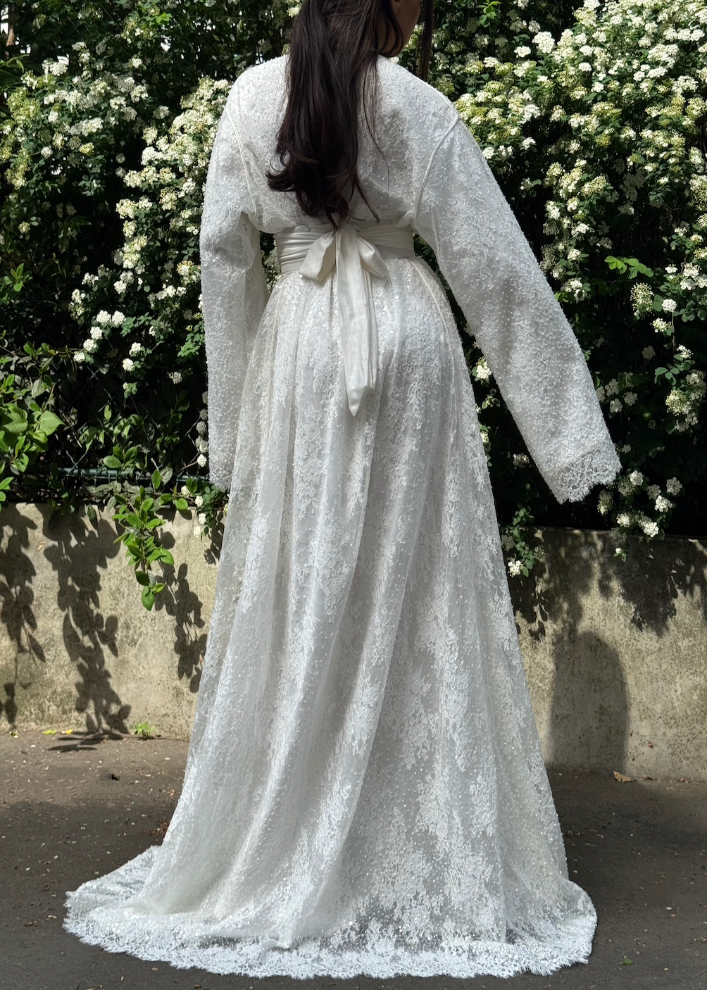 Bridal Kaftan in beaded tulle seen from the back, revealing a fluid fall and delicate finishes on the fabric.