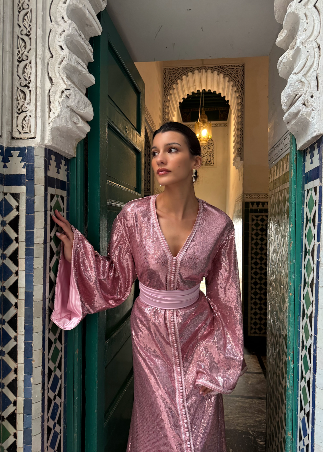 Pink sequined Kaftan captured in motion, highlighting the shimmering reflections of the fabric and the fluidity of the cut.