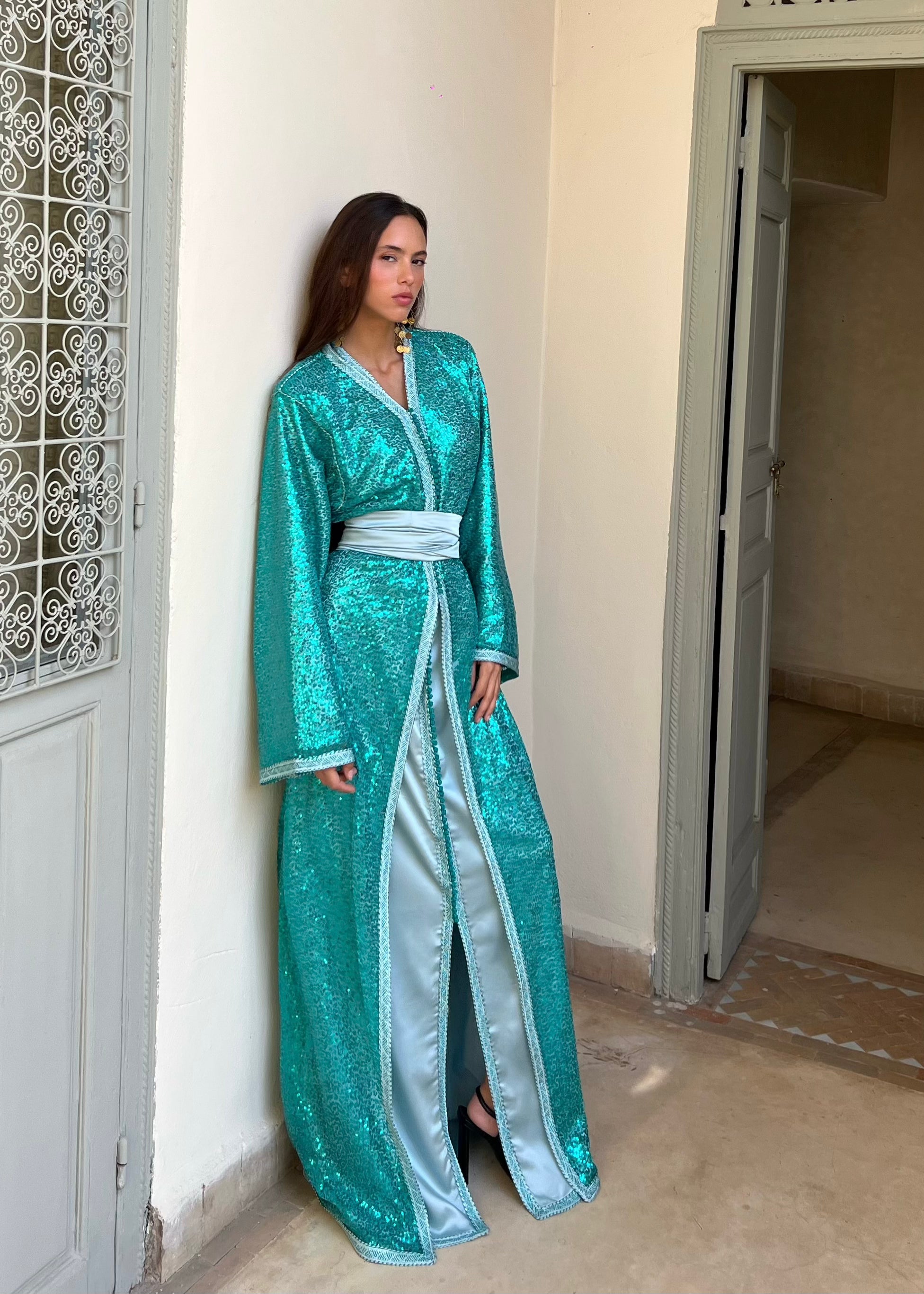Turquoise Kaftan in sequined tulle with silk lining, elegant cut and glittering highlights, front view on model