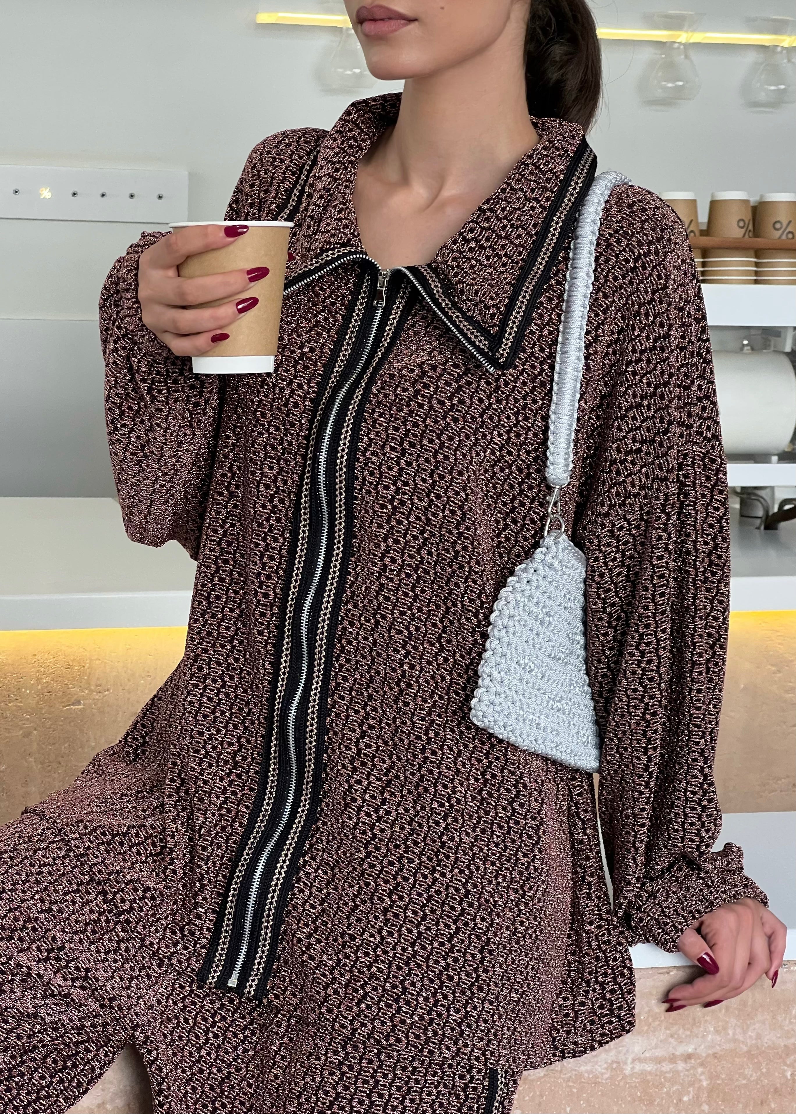 Detail of metallic black and burgundy jacquard brocade, refined texture and high-end couture finishes