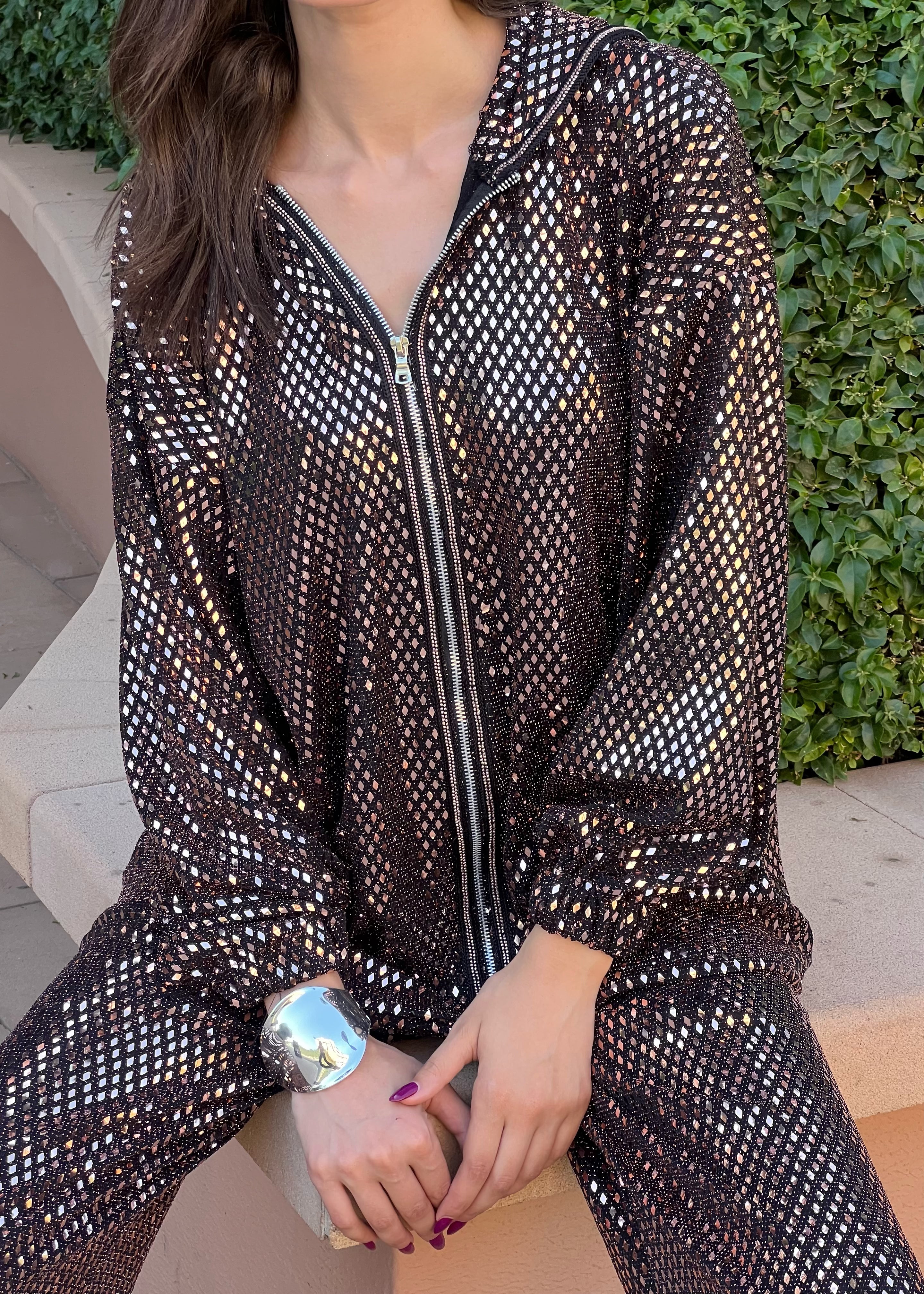 Jacquard sfifa detail on bronze ensemble, hand-stitching and refined finishes on zip and sleeves