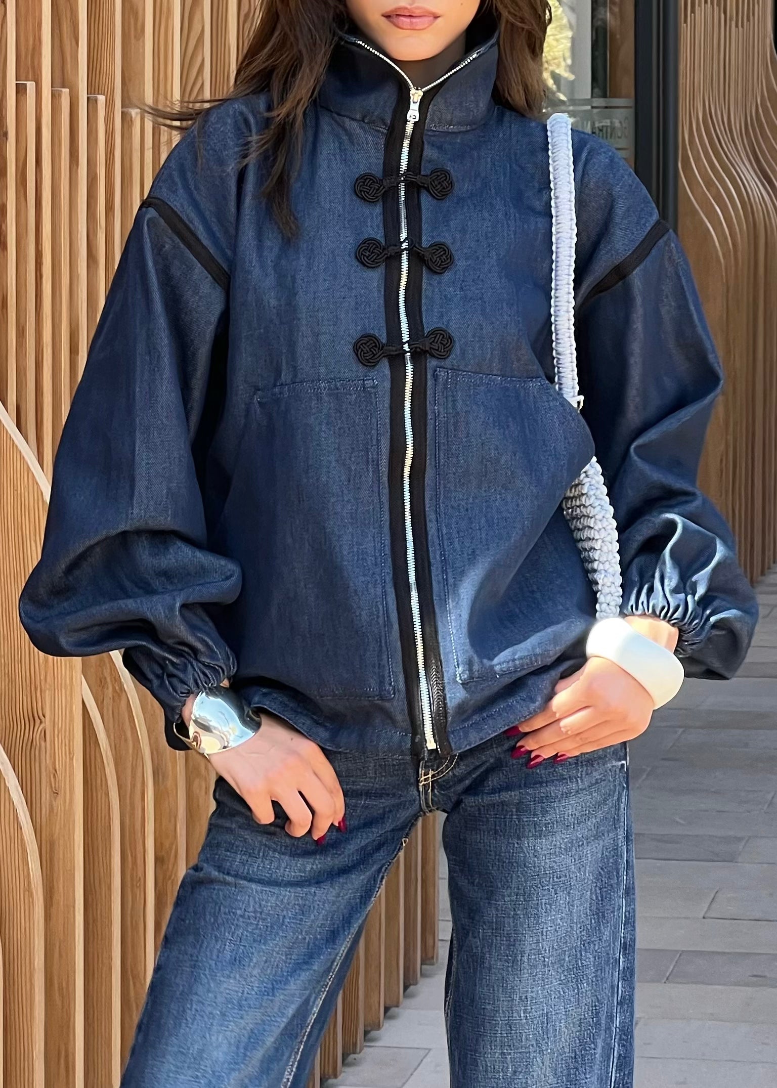 Detail of the black sfifa and Moroccan taîria on the denim jacket, hand-crafted stitching and high-end finishing.