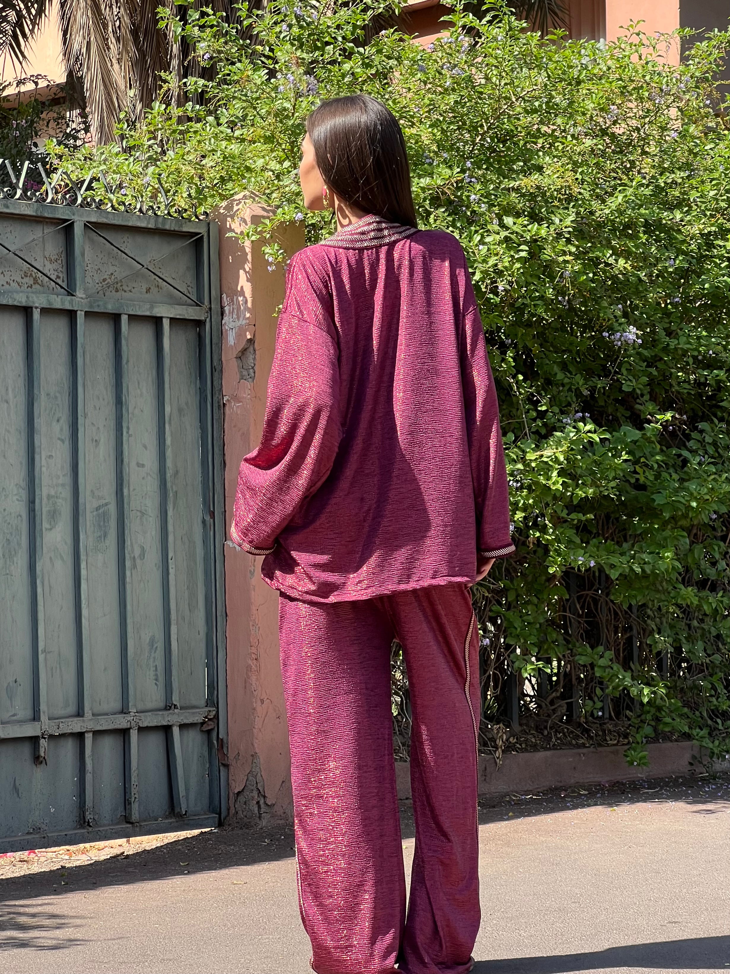 Back of ensemble in burgundy jacquard with sfifas, fluid fabric fall and refined finishes