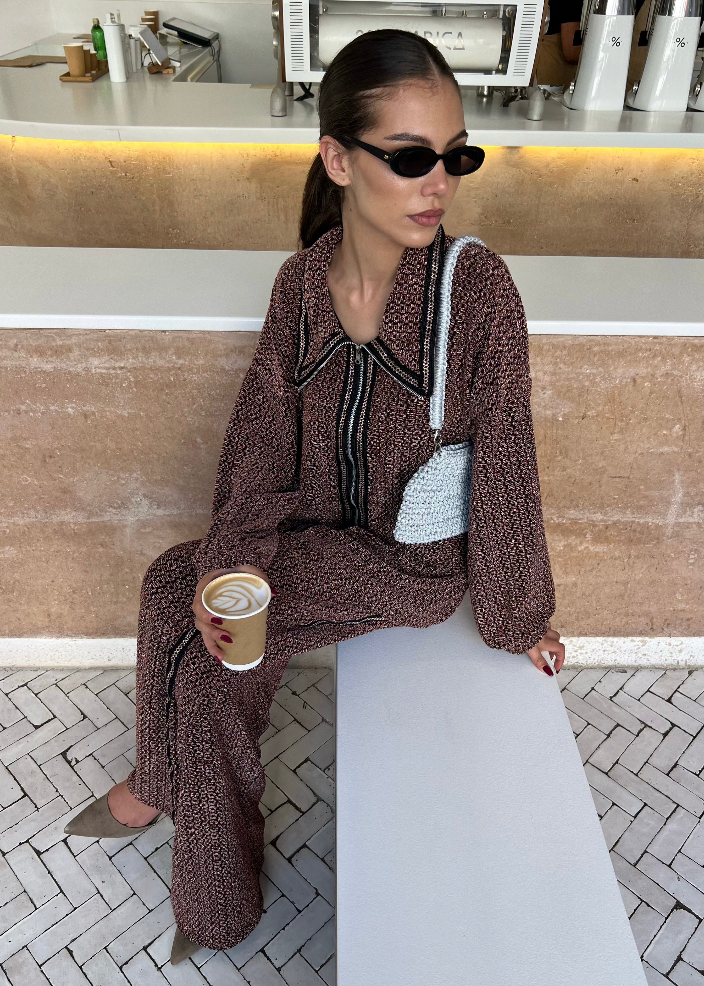 Sweatshirt and pant set in black and burgundy metallic brocaded jacquard worn by model, modern and sophisticated look