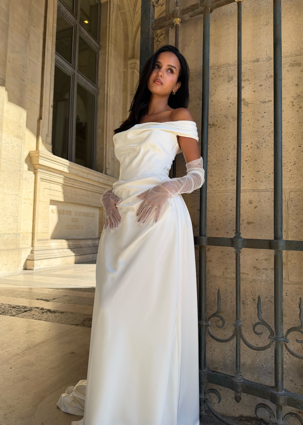 Front view of a bride wearing elegant, detachable transparent tulle sleeves.
