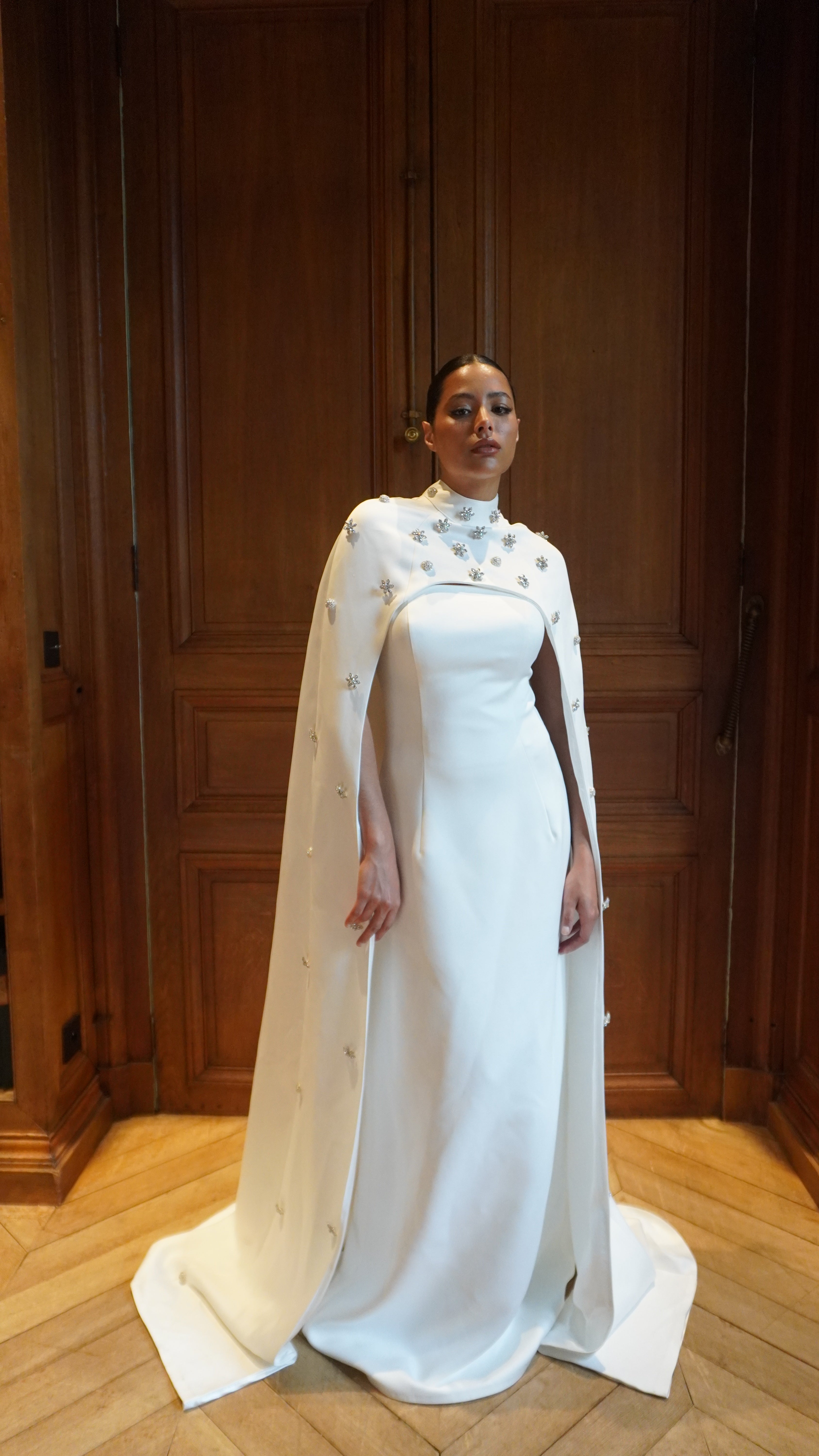 Strapless straight wedding dress captured in motion, highlighting the fluidity of the fabric and the elegance of the train.