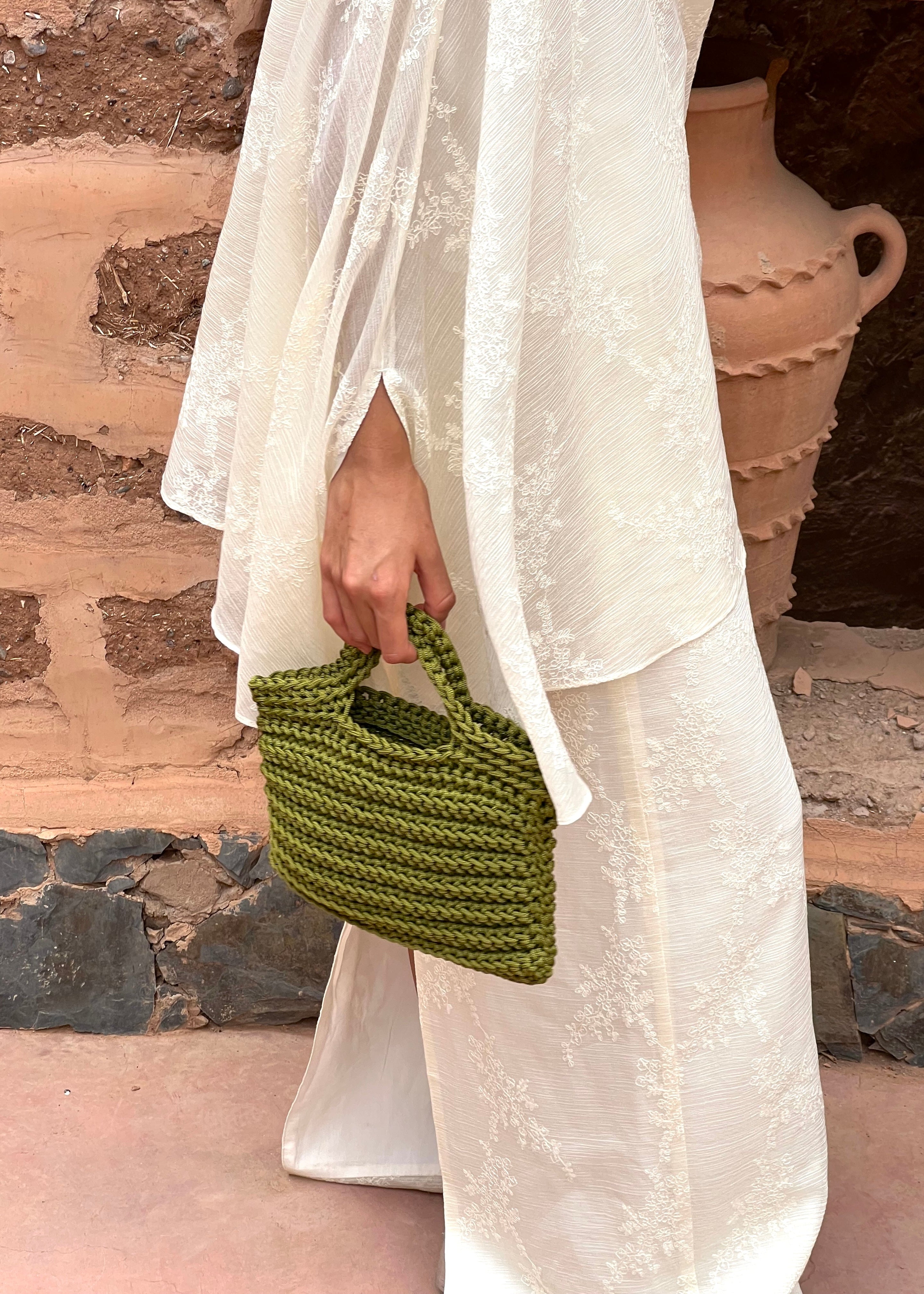 Close-up of khaki green crochet bag handmade in Marrakech, texture and finishing touches