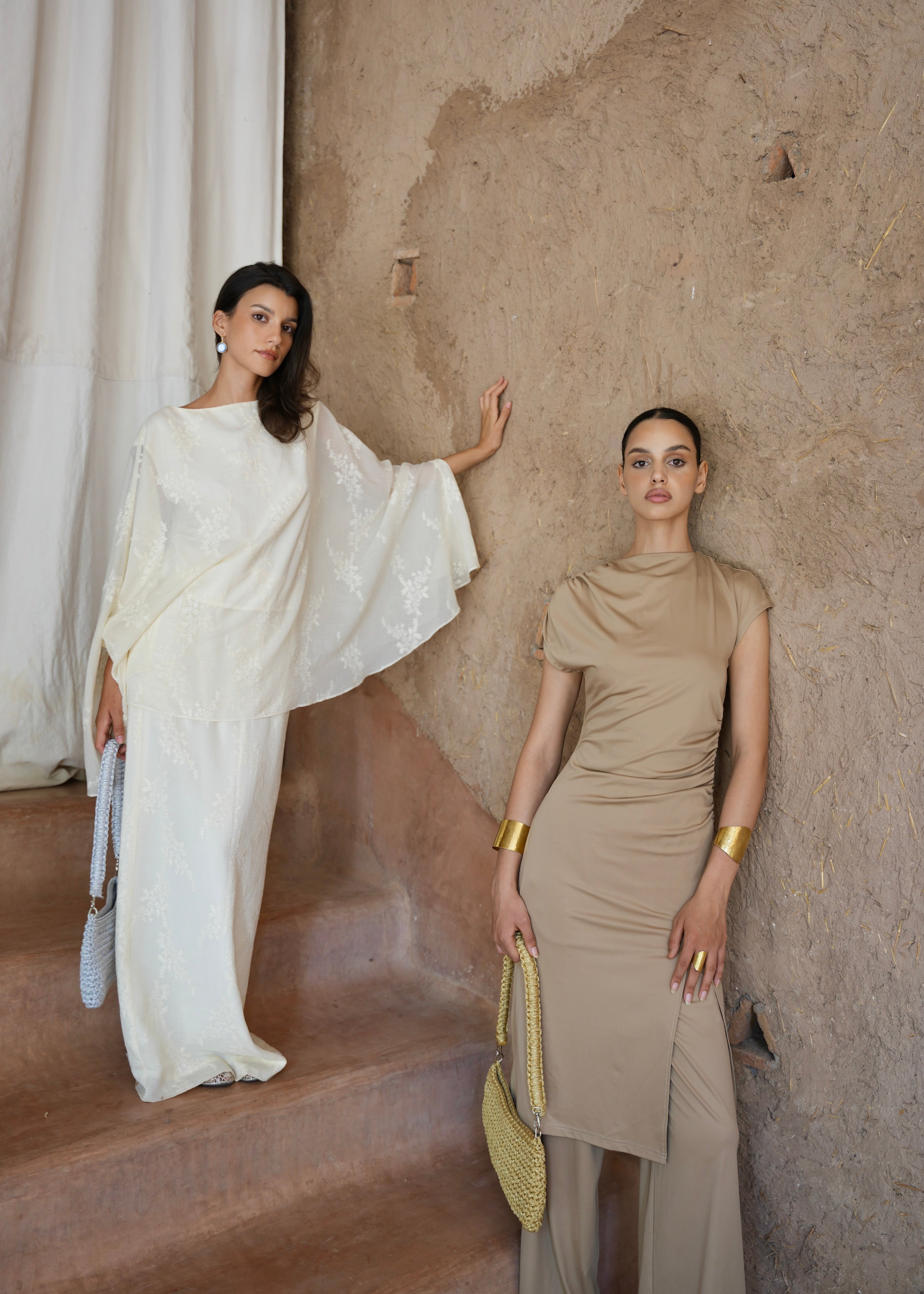 Two models wearing the silver crochet trapeze bag, full-length view, Moroccan craftsmanship