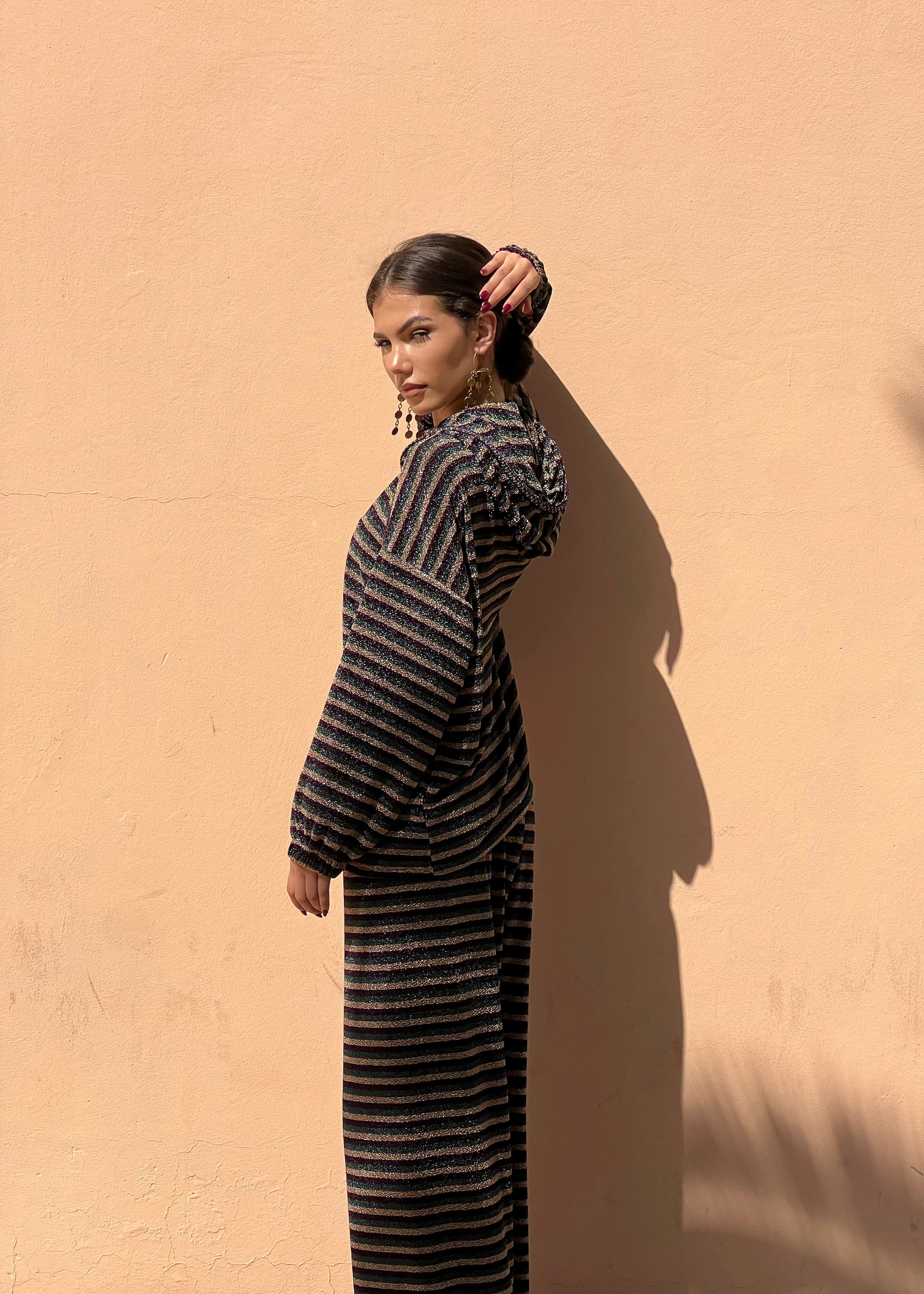 Profile of zip-up hoodie and pants in gold, green and burgundy brocaded jacquard, contrasting sfifa on edges and sleeves