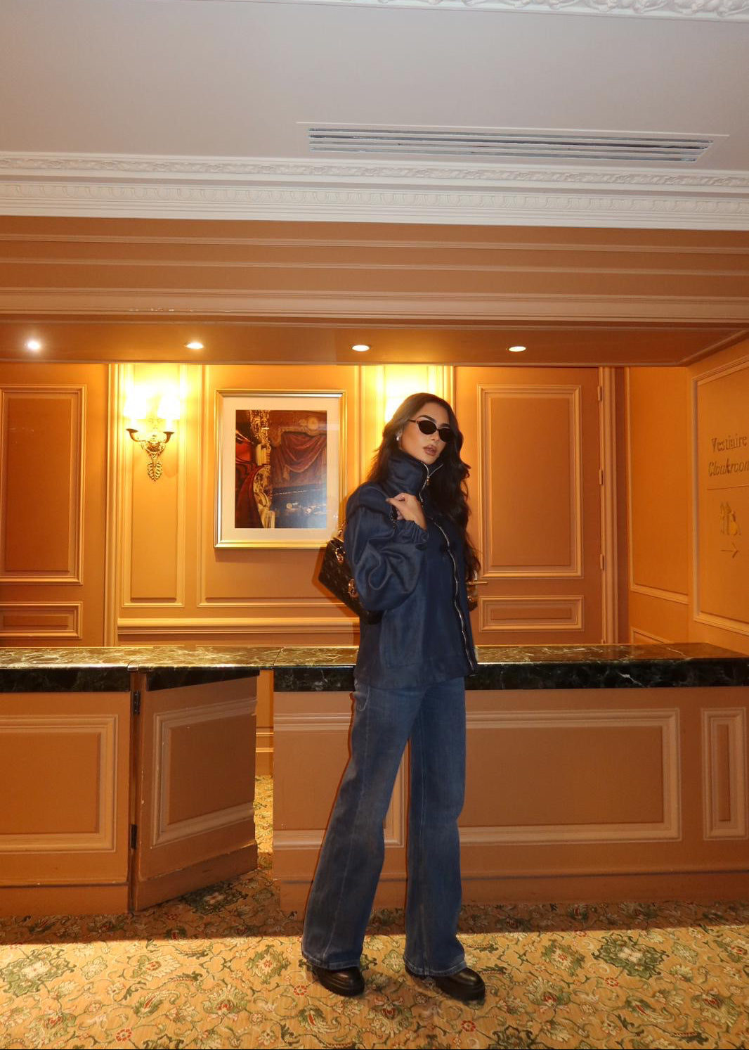 Zippered denim jacket with black sfifa and Moroccan taîria, full-length view in lifestyle situation worn by mannequin.