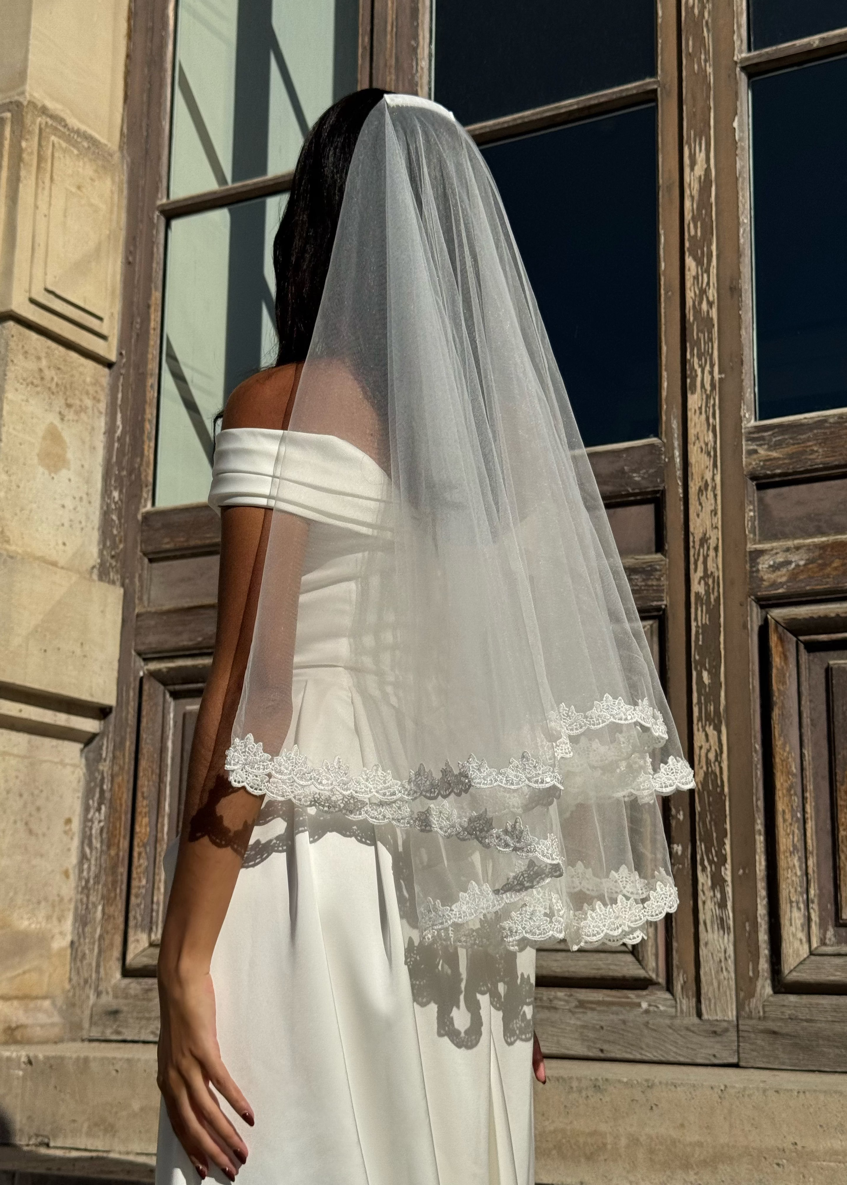 Detail of the floral lace border of the short wedding veil