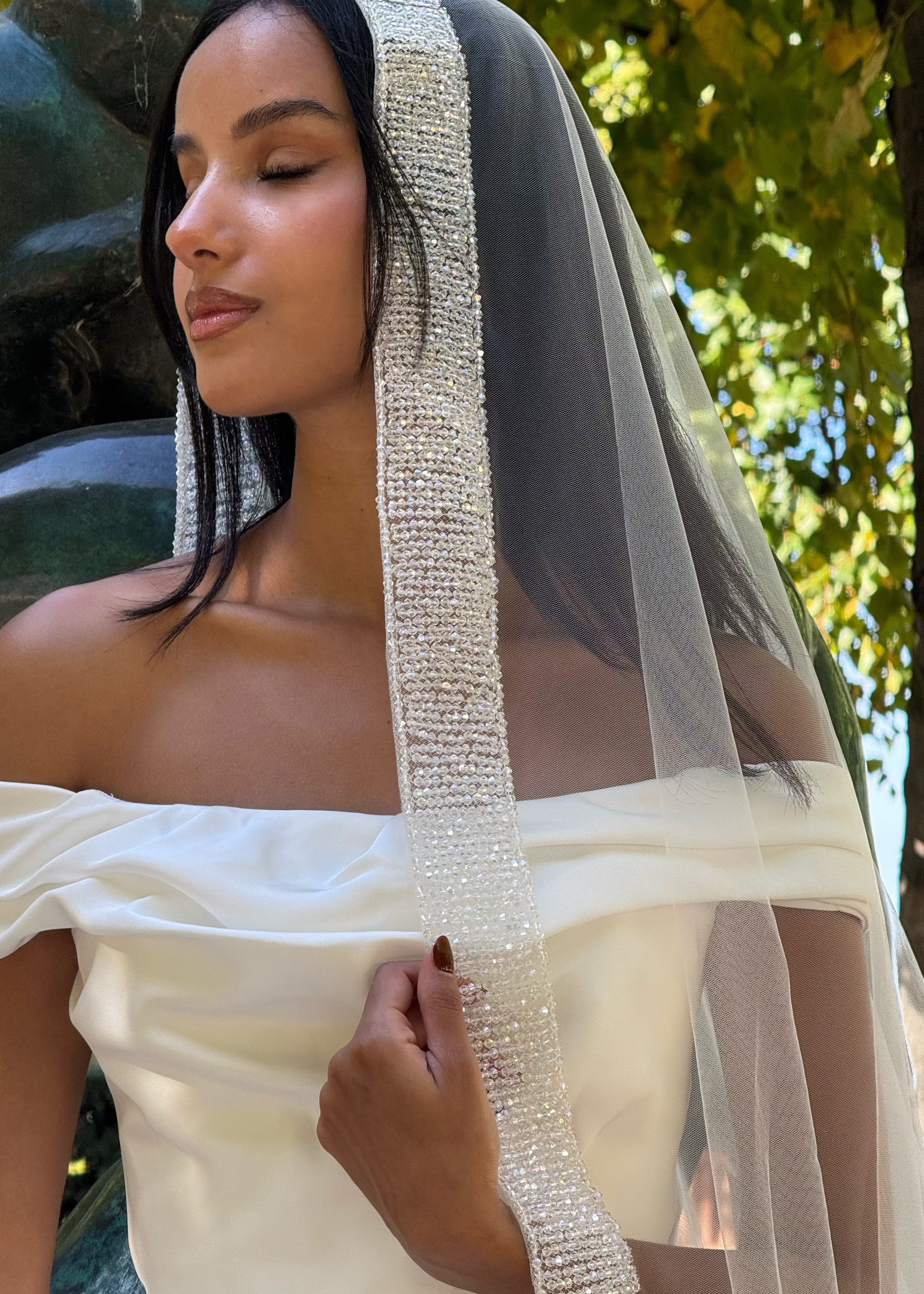 Detail of the delicately sewn pearls and shimmering border on the bridal veil.