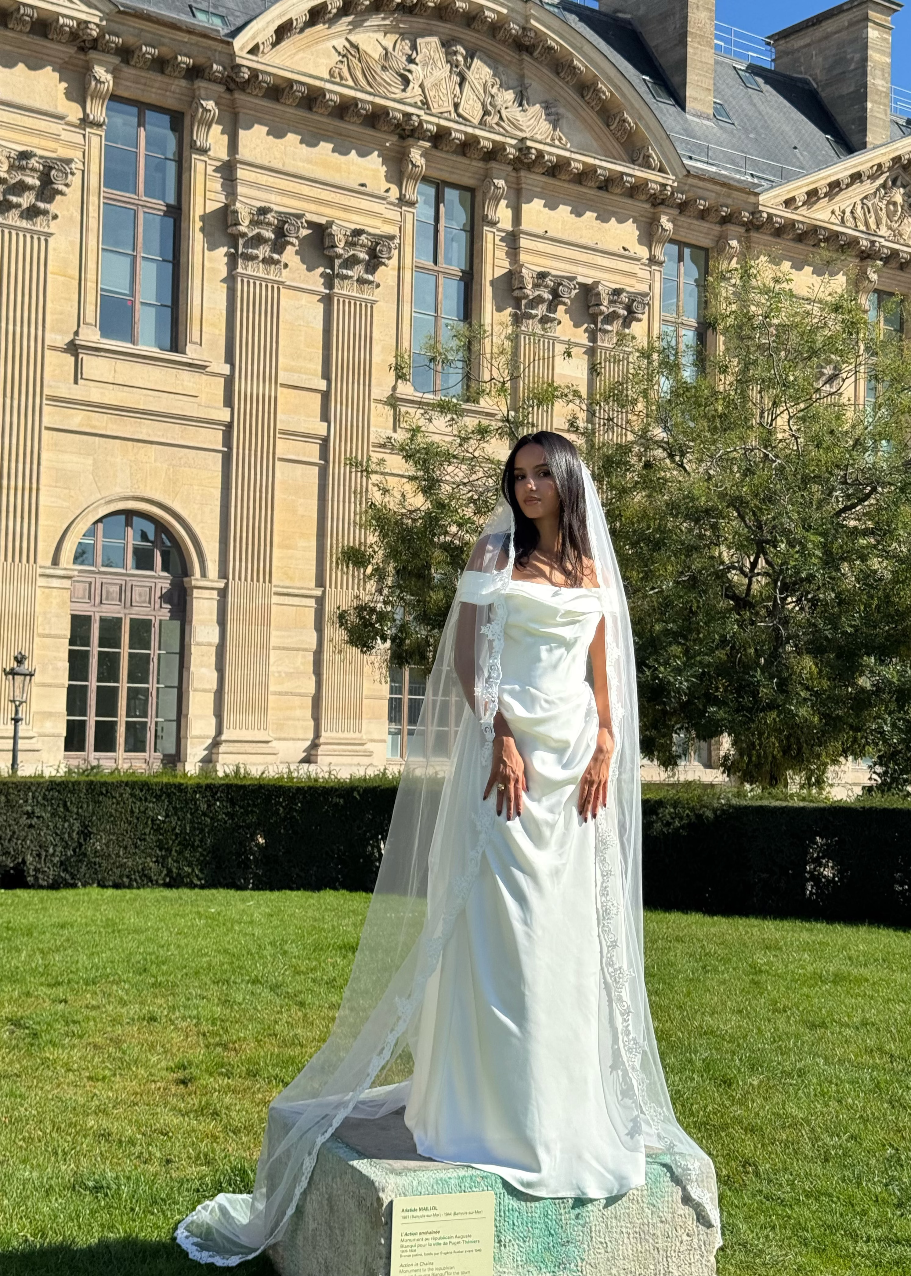 Side view of long bridal veil with floral lace trim.