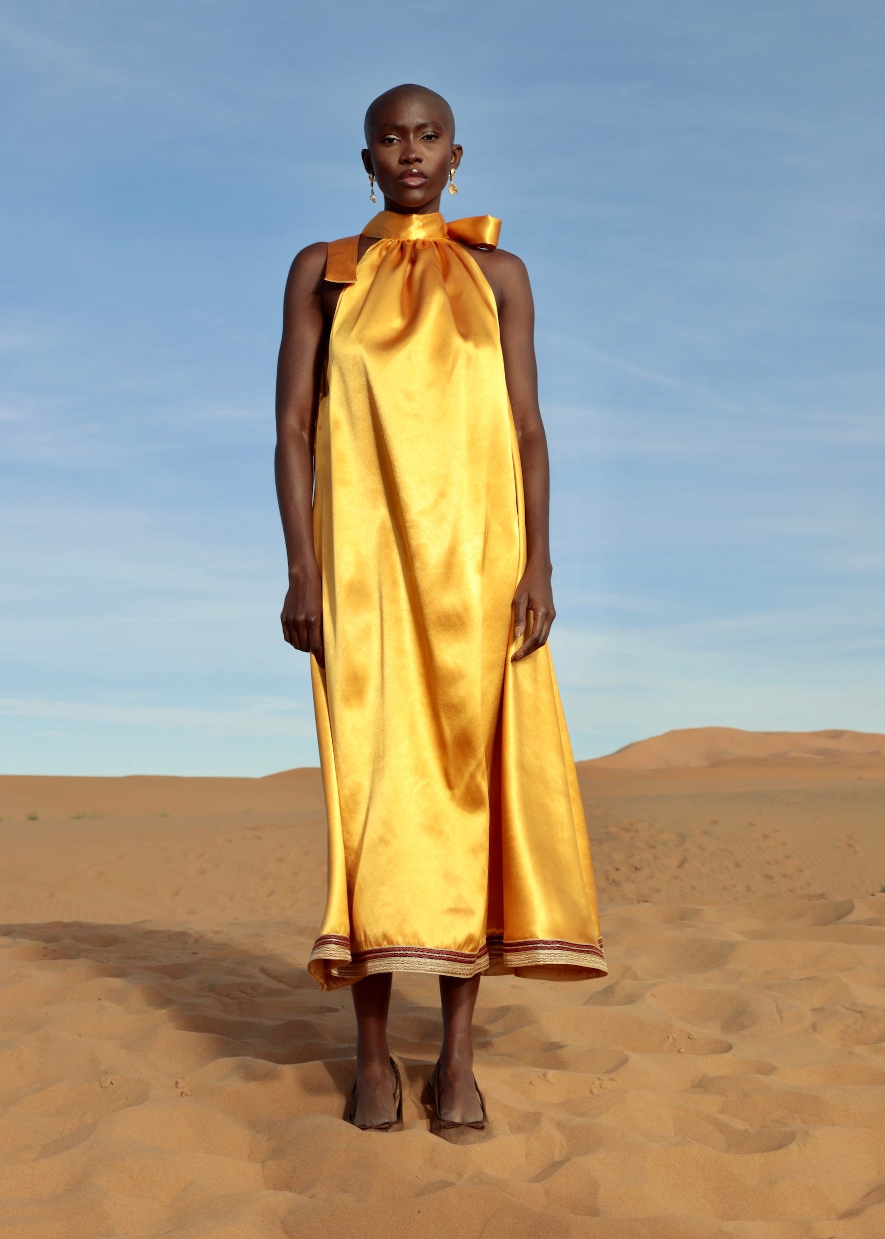 Orange duchesse satin dress embellished with handcrafted sfifa, front view.