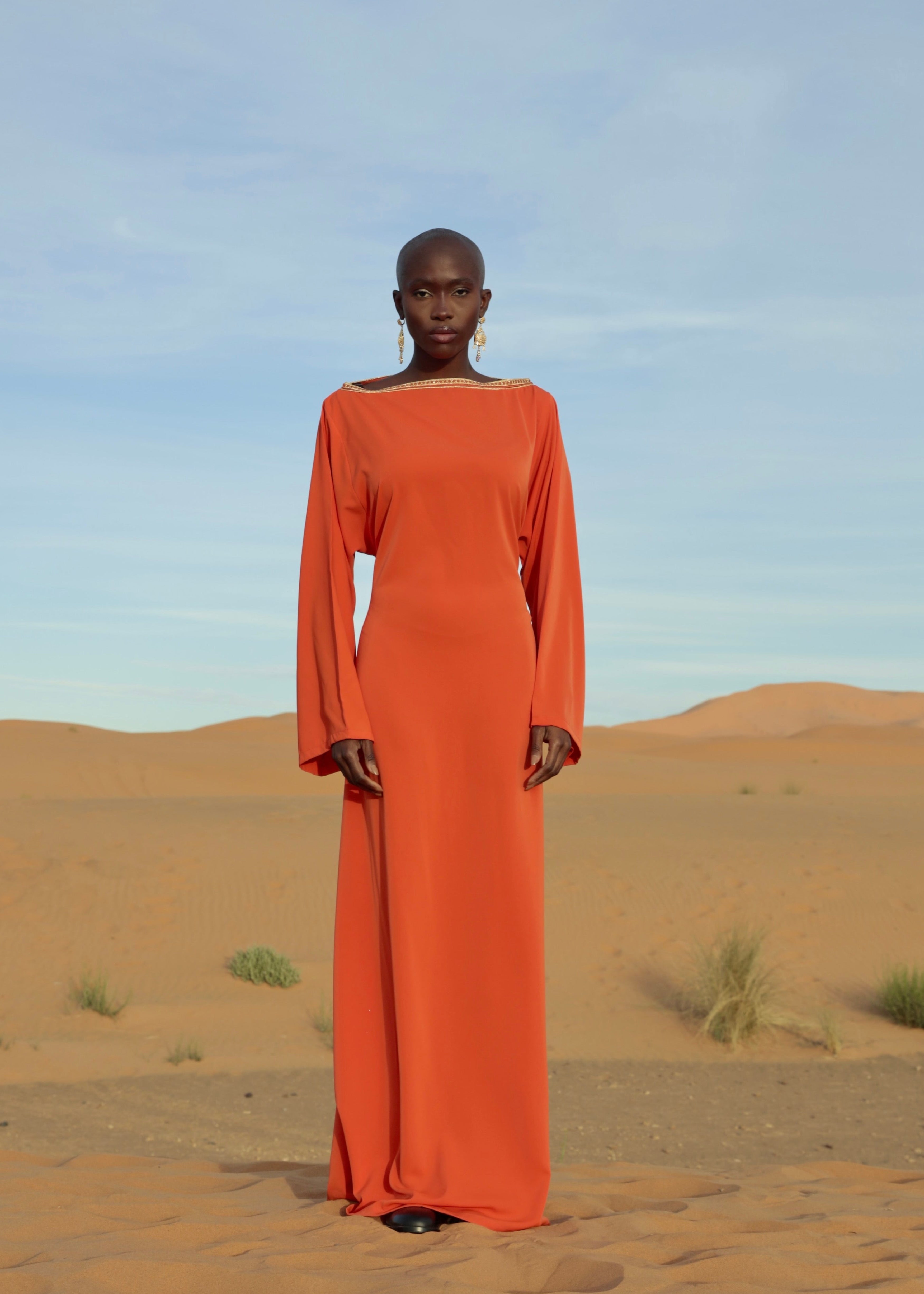 An orange printed dress with a lamé silk back, highlighting the fabric's lightness and shimmer.