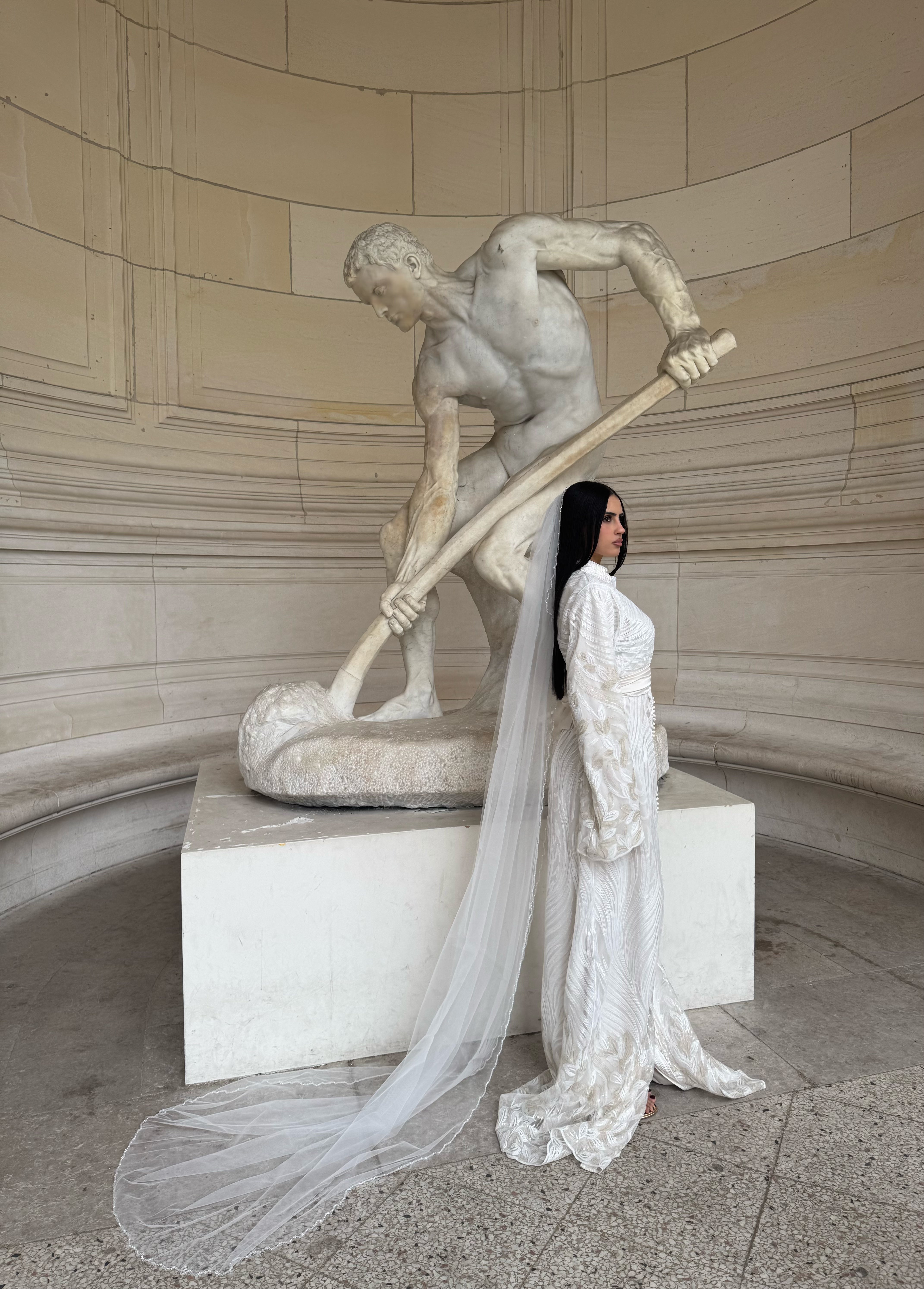 White textured Kaftan worn from the side, featuring a long, flowing silhouette
