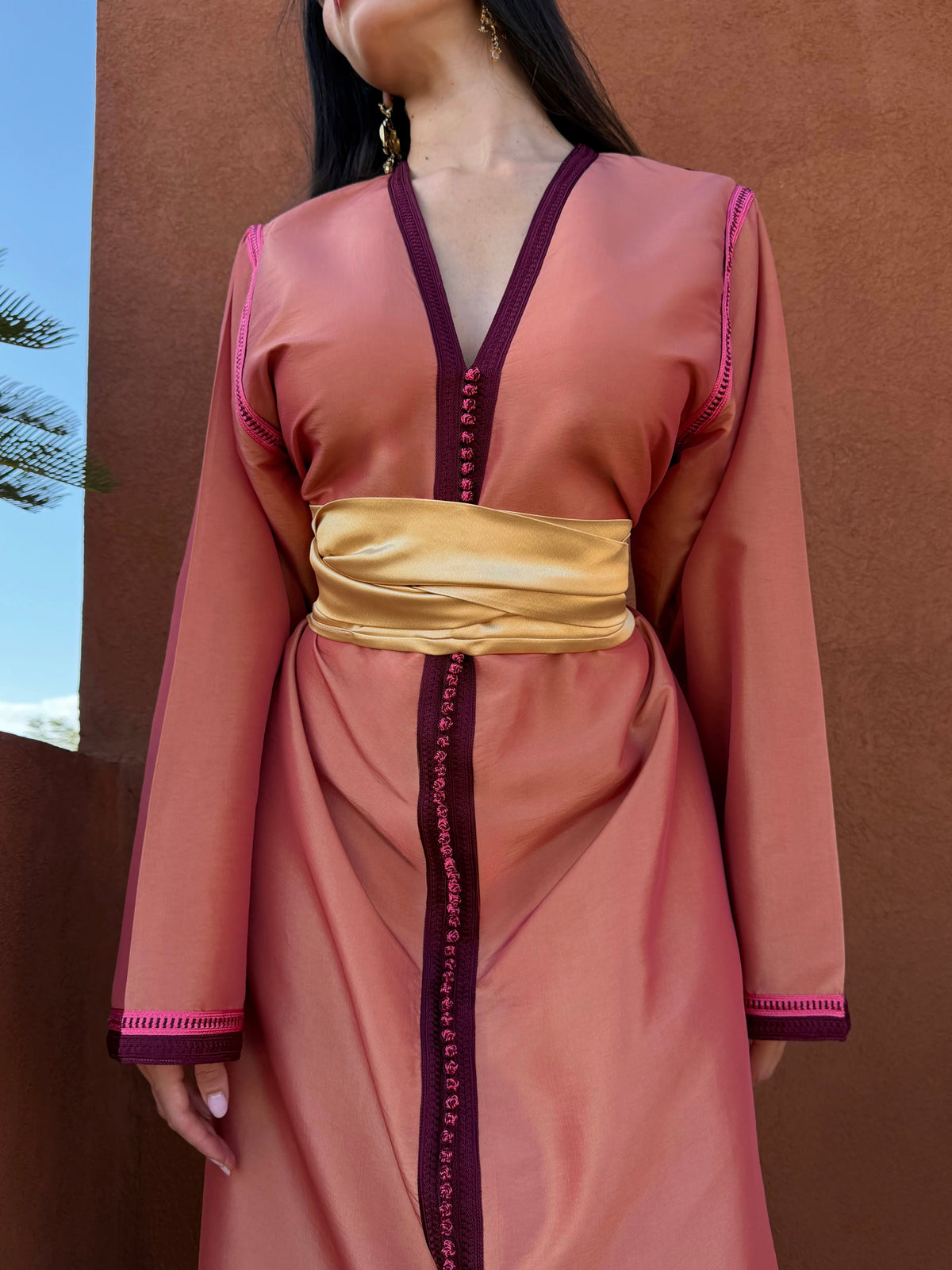Caftan Pêche à Sfifa Prune — Détail de l’encolure prune et de la ceinture.