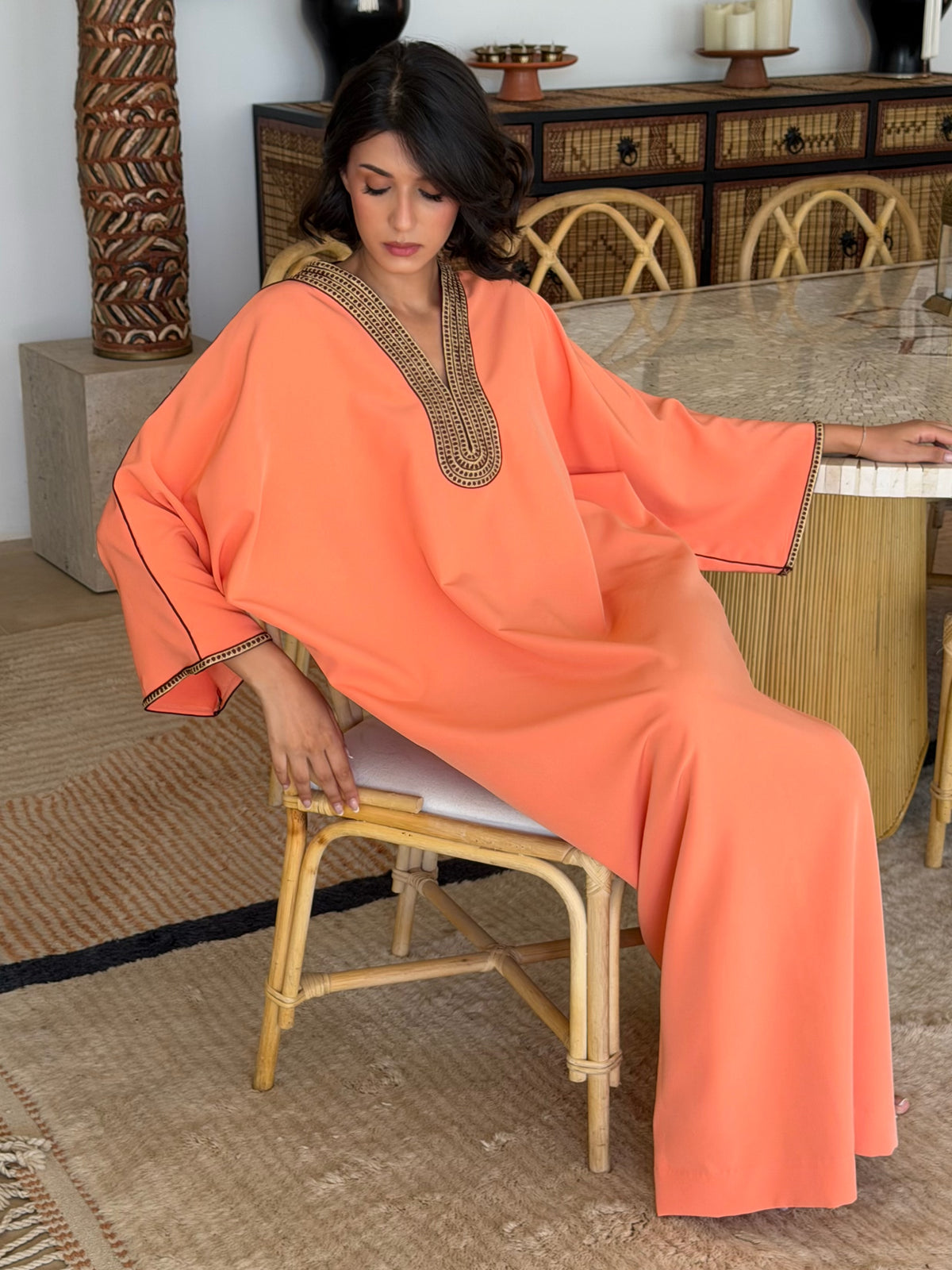 Robe Longue Corail aux Finitions Bordeaux — Vue assise montrant le volume des manches.