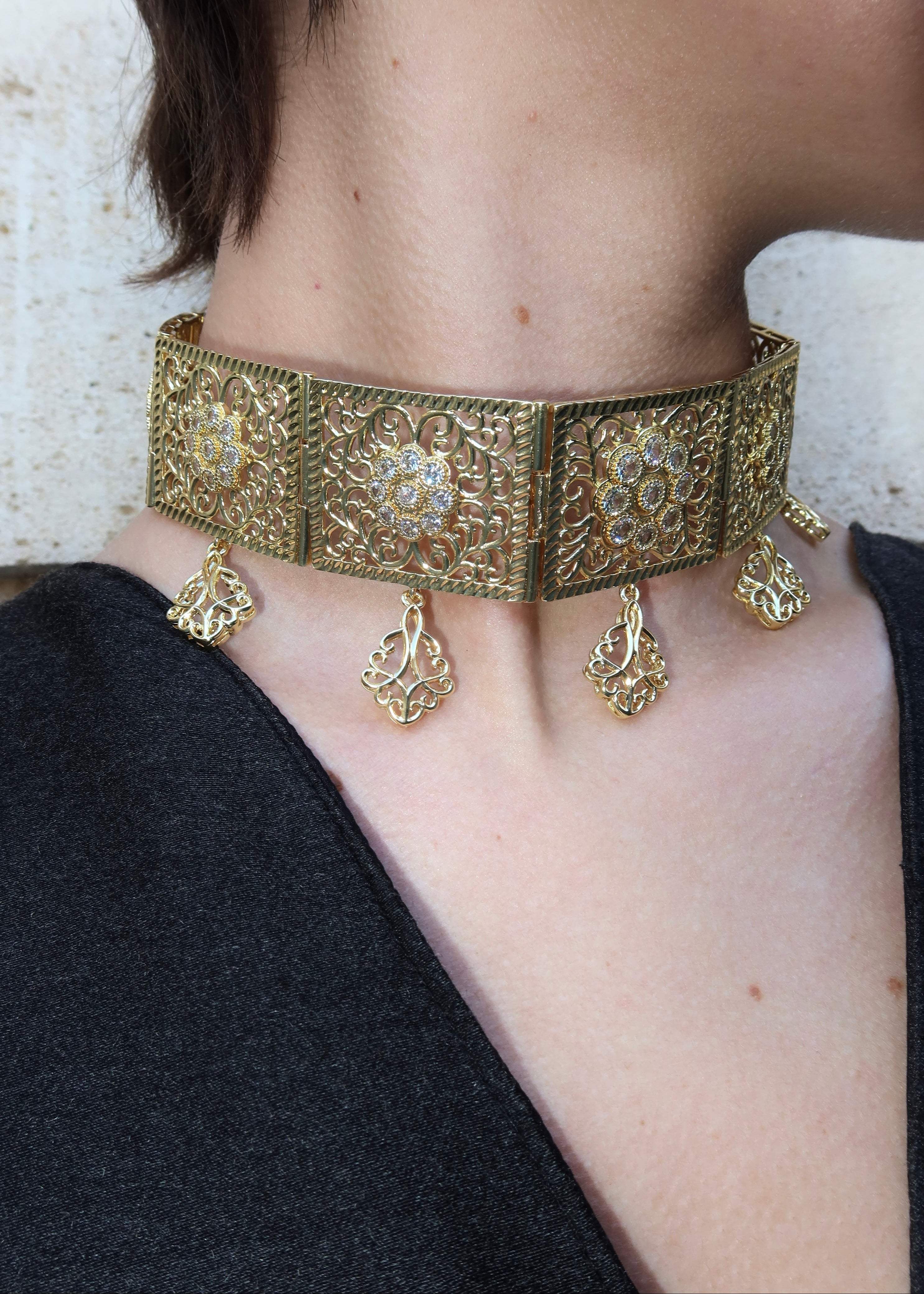 A gold statement necklace worn with formal attire