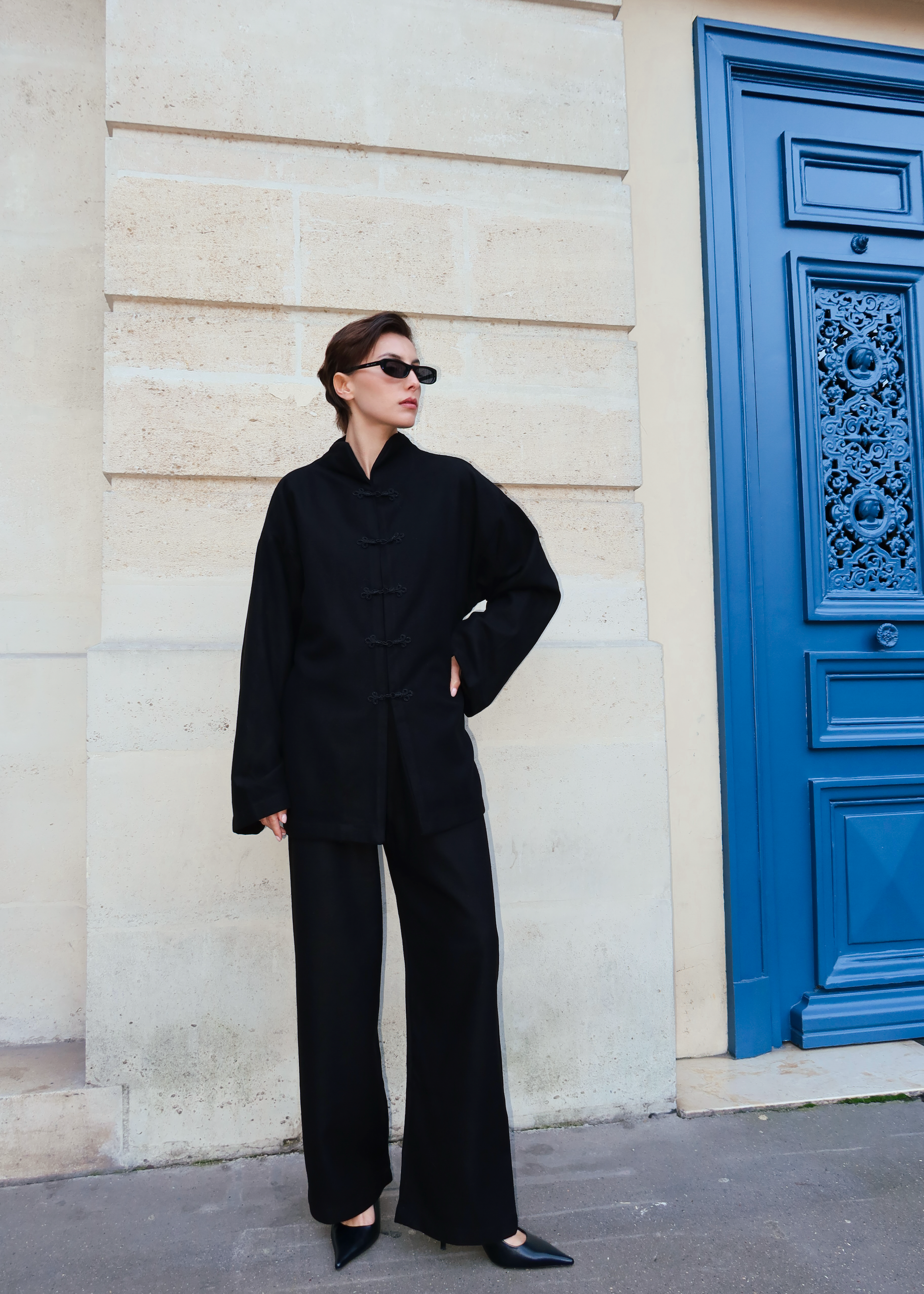 Black cashmere ensemble photographed full length, with Moroccan buttons and chic style