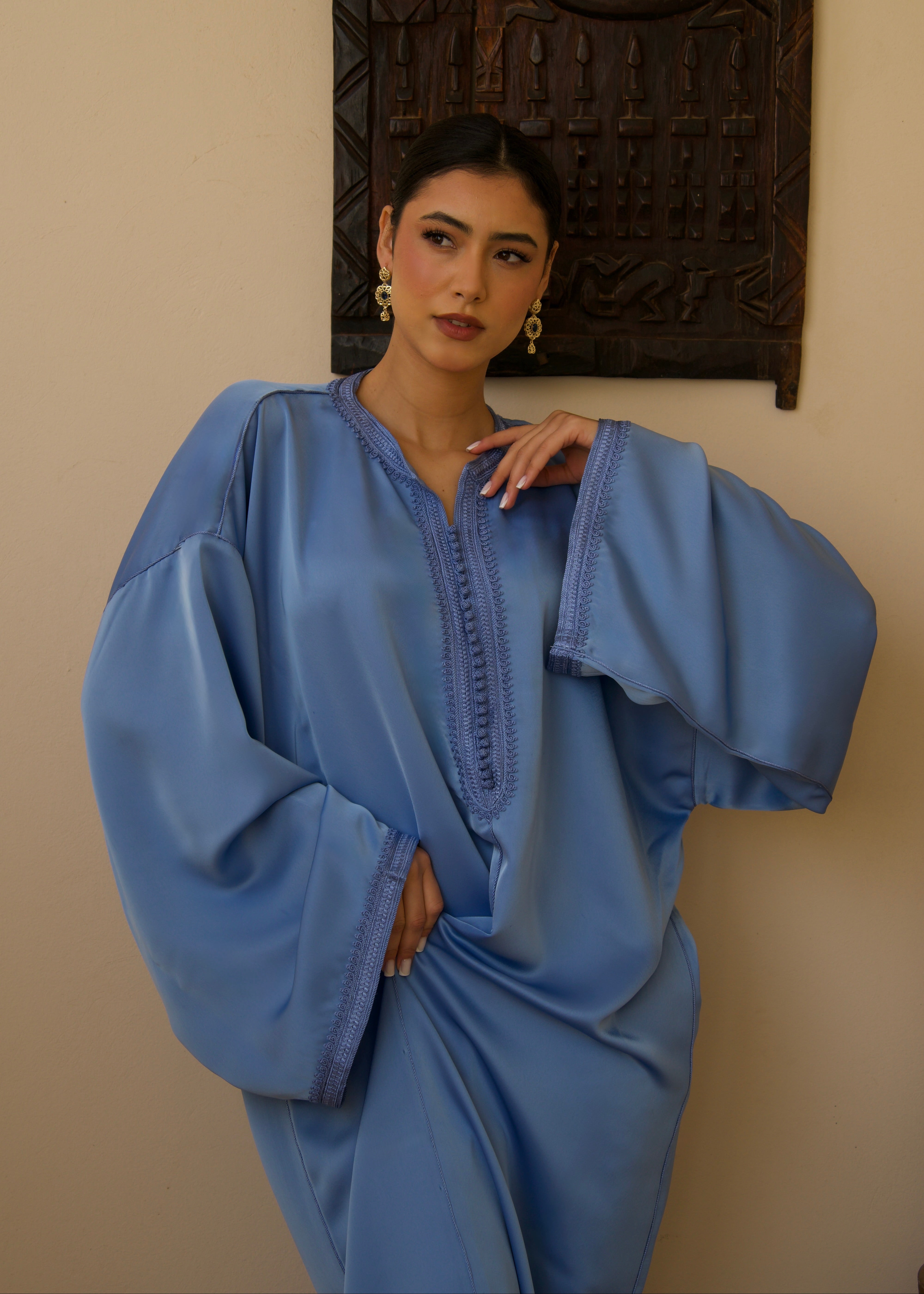 Blue duchess satin jellaba decorated with sfifa, front view.