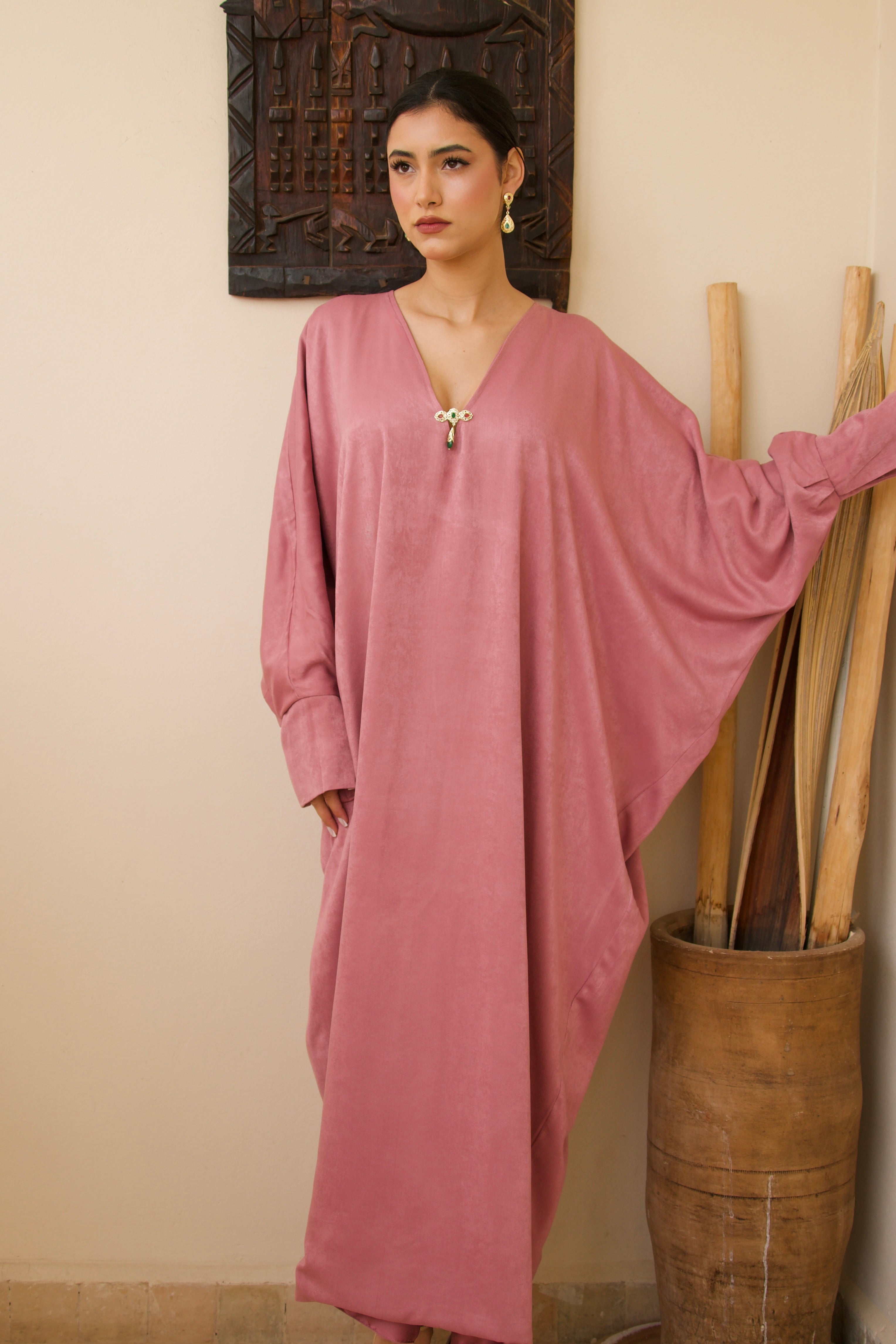 Long pink silk mlifa dress worn in motion, flowing and elegant fabric.
