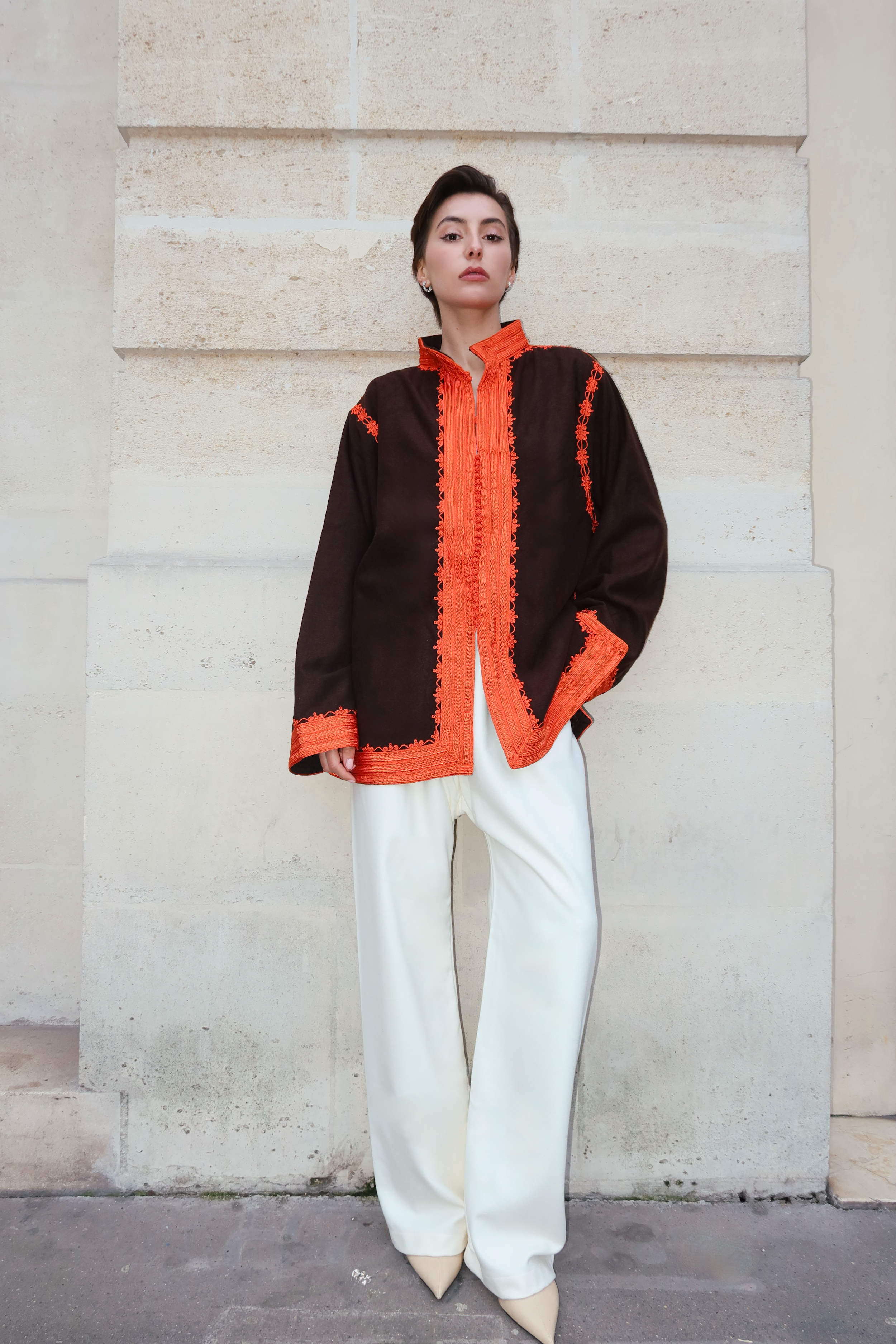 Brown cashmere jacket photographed full length, with orange embroidery and chic style