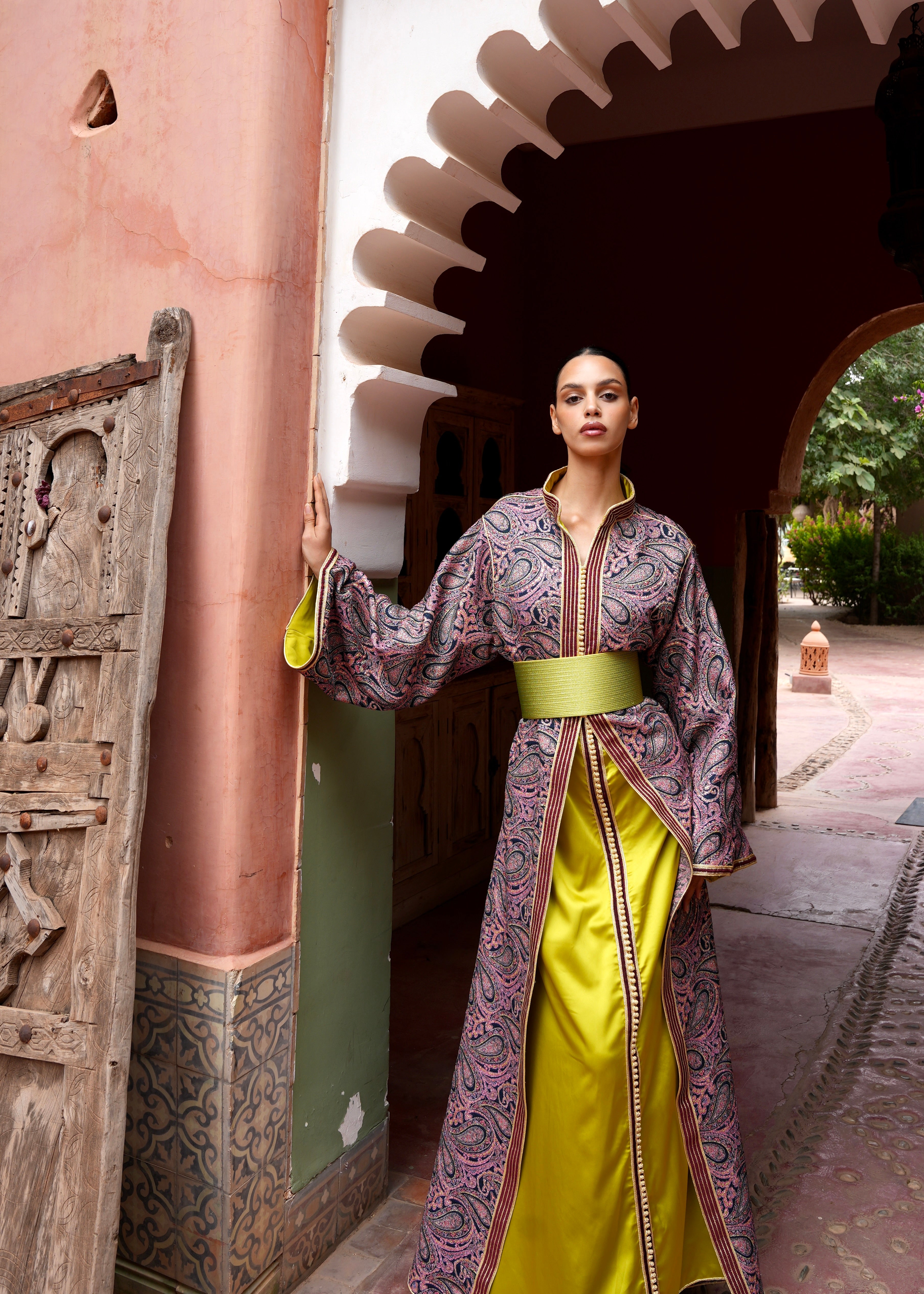 Full-length view of a model wearing a burgundy and green brocade collar Kaftan