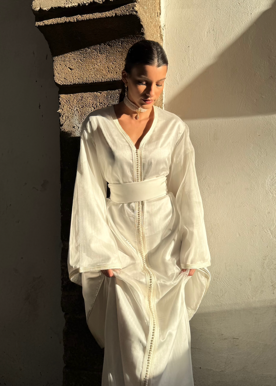 White organza bridal Kaftan captured in motion, highlighting the airy lightness of the fabric and the softness of the drape.