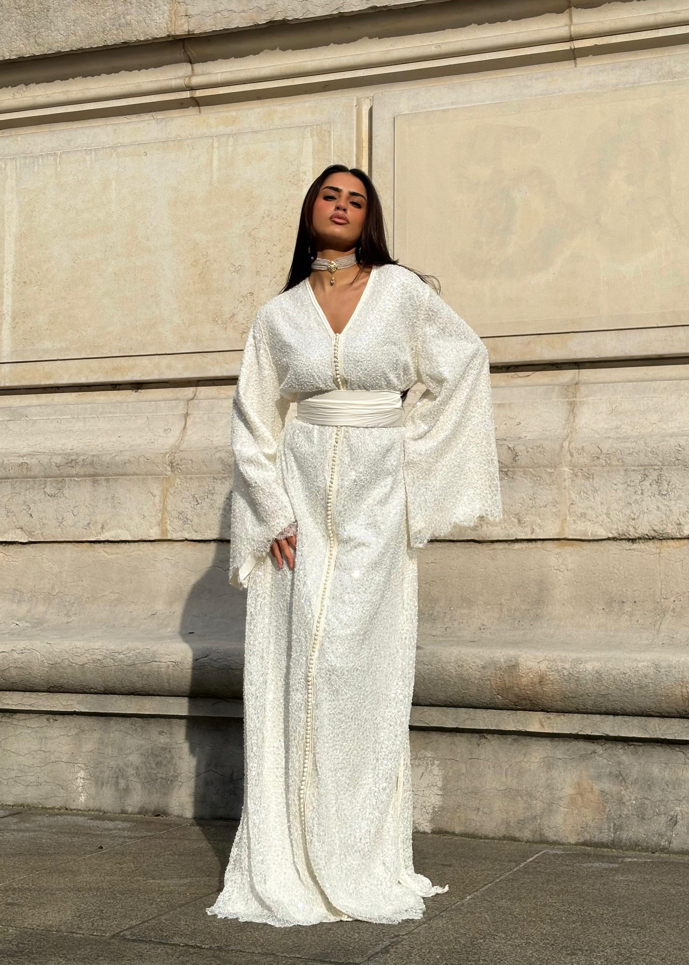 Beaded bridal Kaftan with flared sleeves seen from the front, showcasing an elegant silhouette and finely embroidered beads.