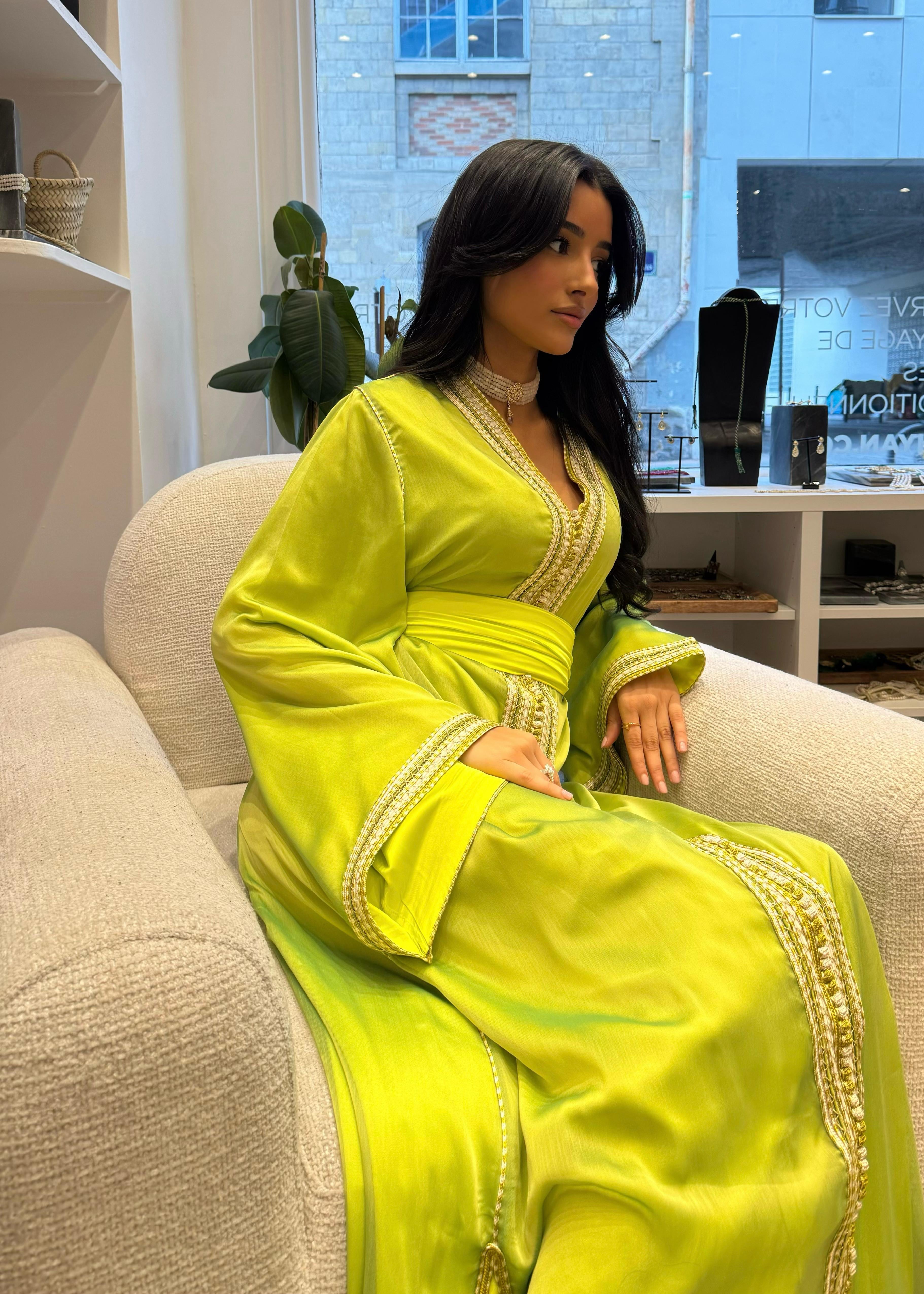 Green chiffon Kaftan captured in motion, highlighting the airy lightness of the fabric and the softness of the drape.