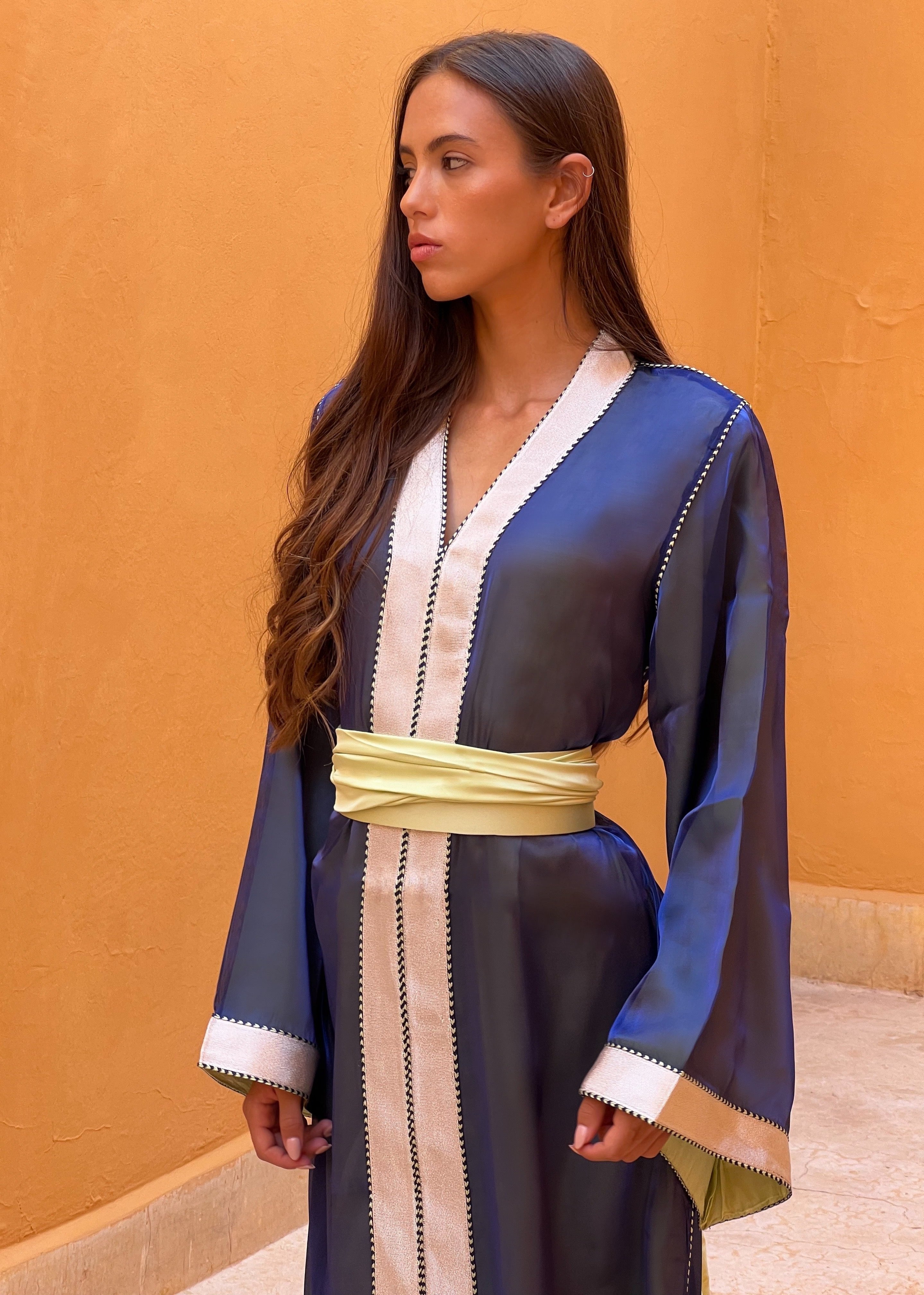Blue organza Kaftan captured in motion, highlighting the fluidity of the fabric and the light reflections of blue.